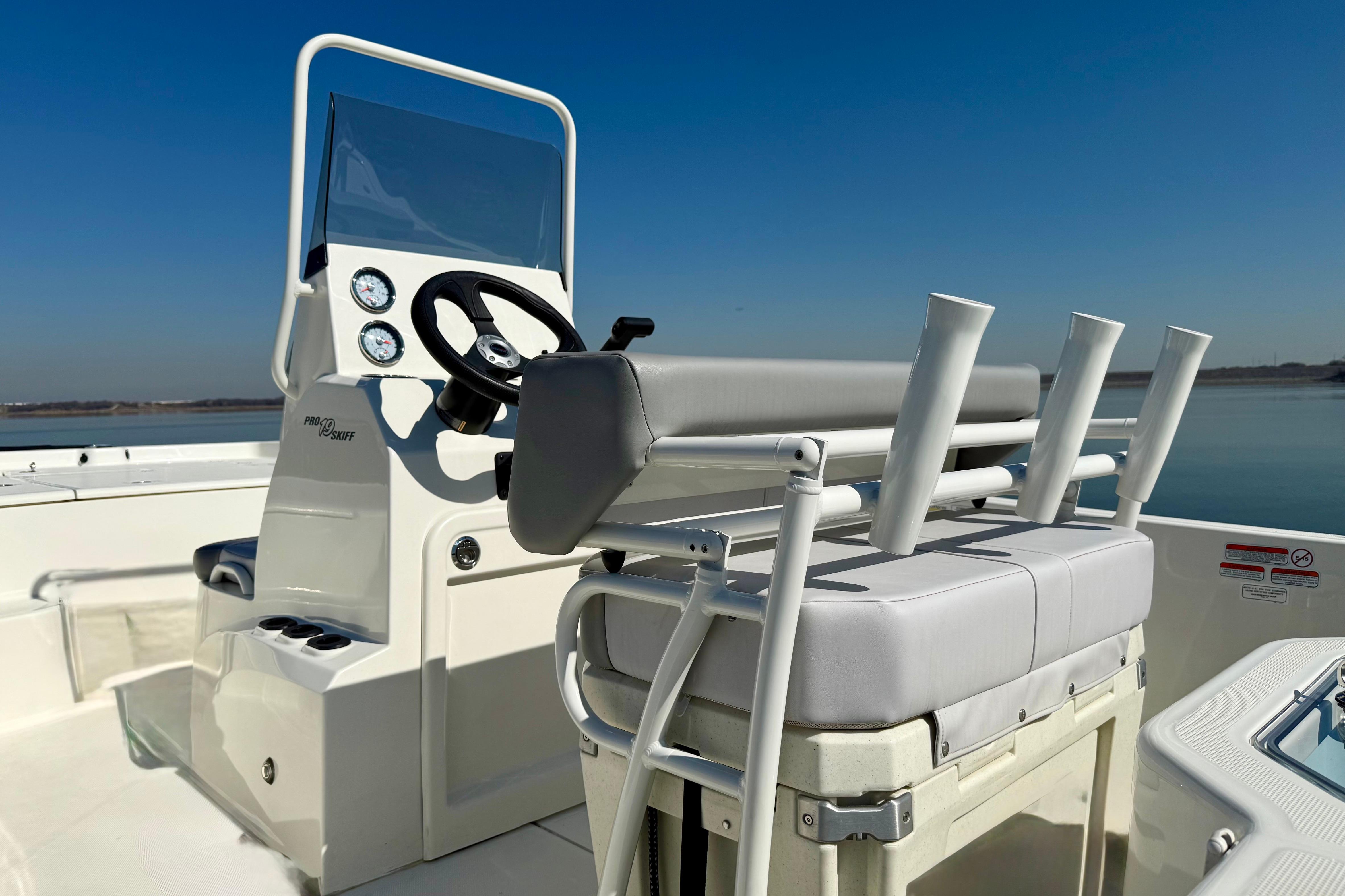 2024 Mako Pro Skiff 19 CC boat interior with steering console and rod holders.