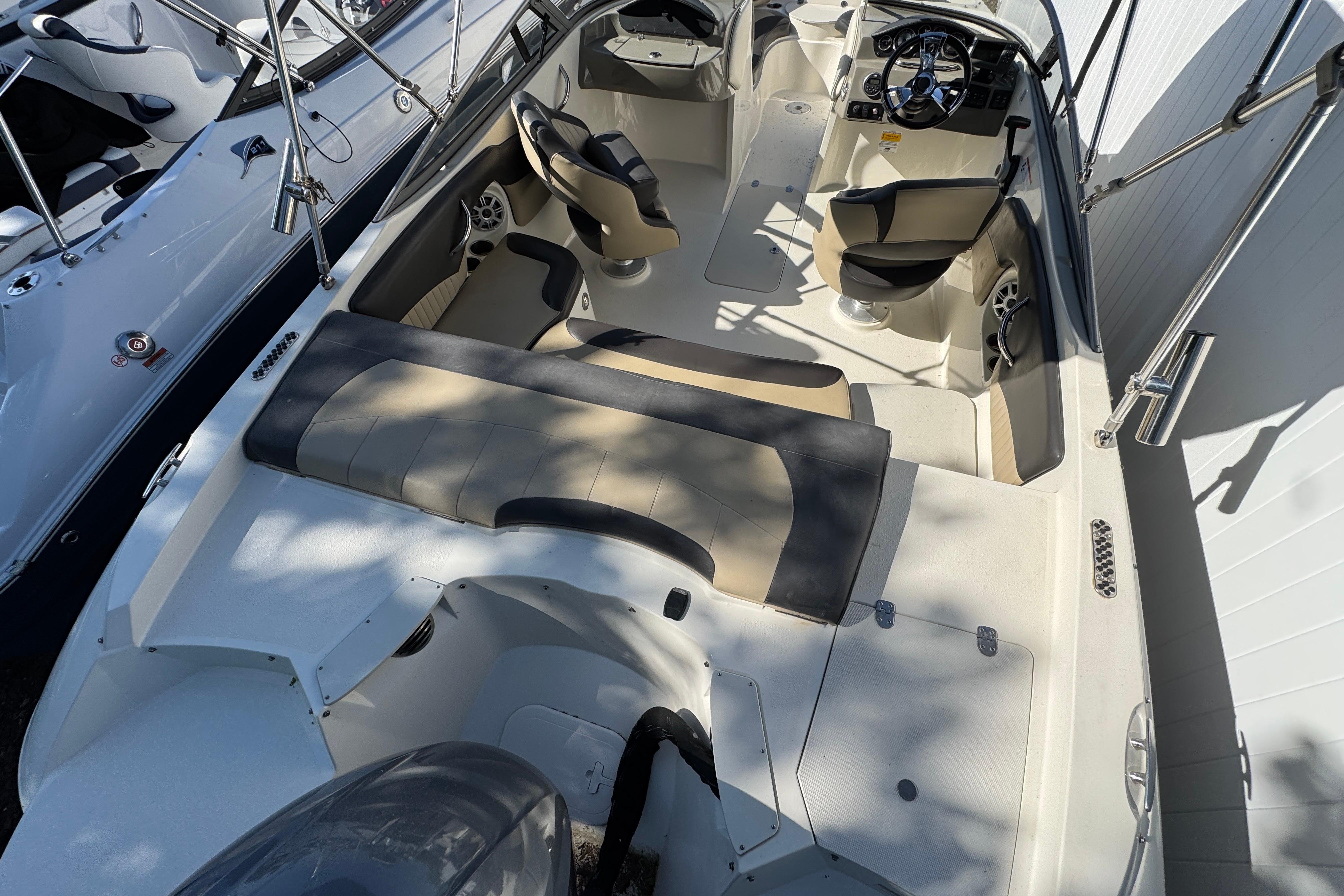 2018 Stingray 204 LR boat interior with seating and steering console.