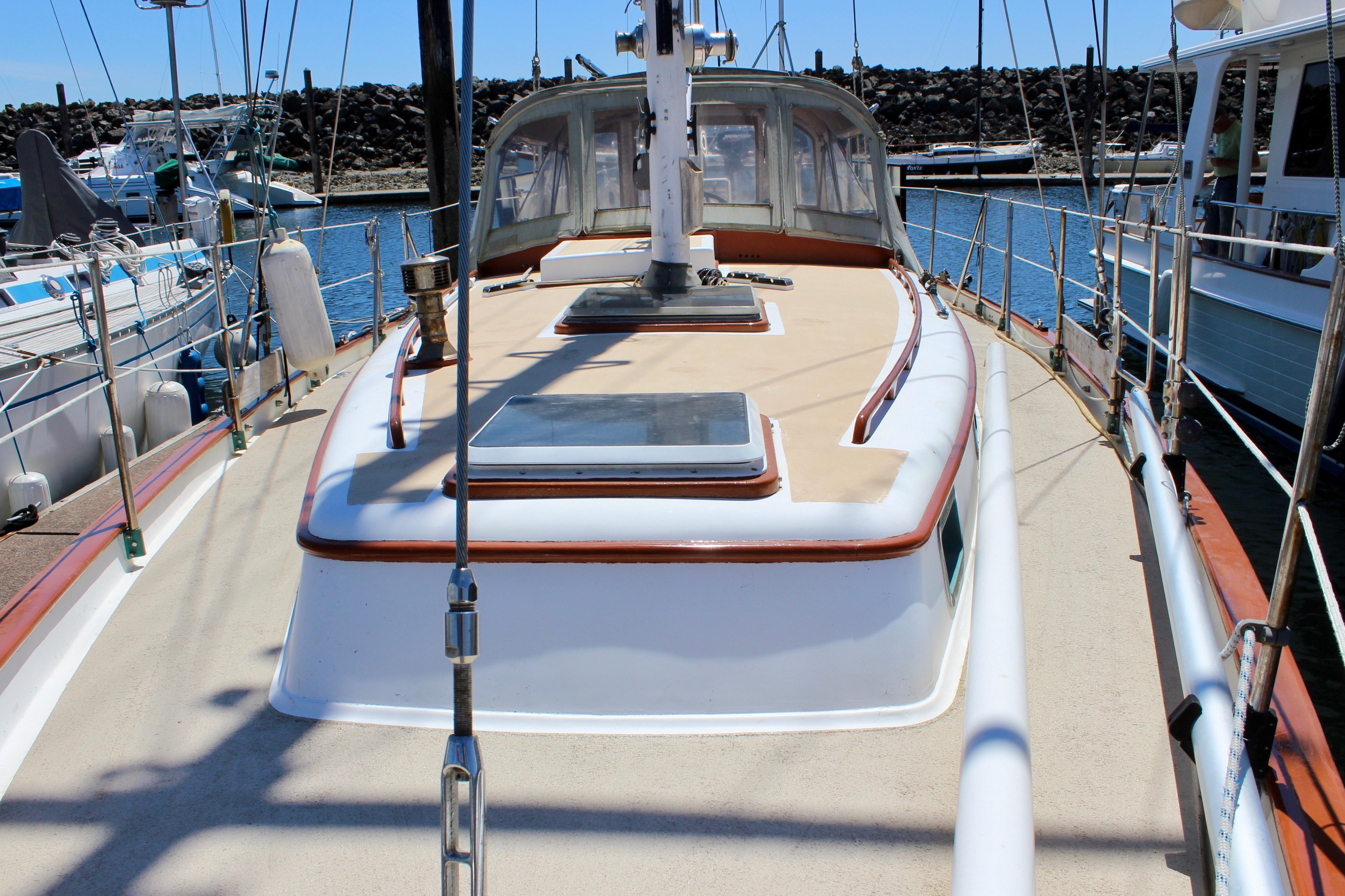 1981 Kelly Peterson 46 sailboat docked at marina, showcasing deck and cabin details.