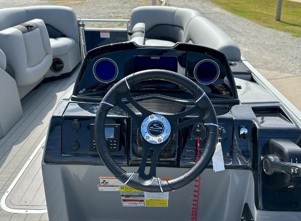 2024 Landau ATLANTIS 230C helm with steering wheel and controls.