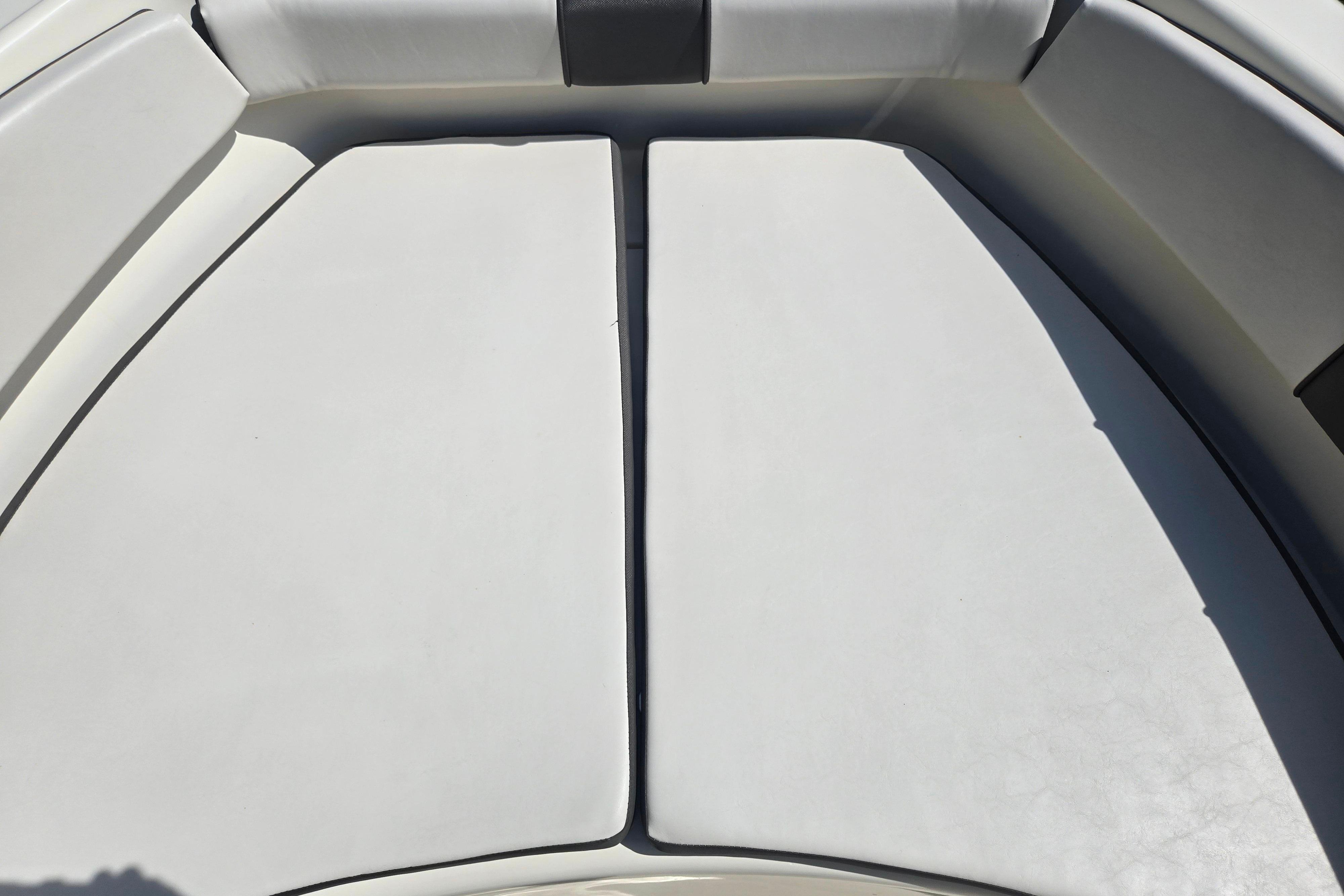 Interior seating of a 2016 Key Largo 2000CC boat, featuring white cushioned seats.