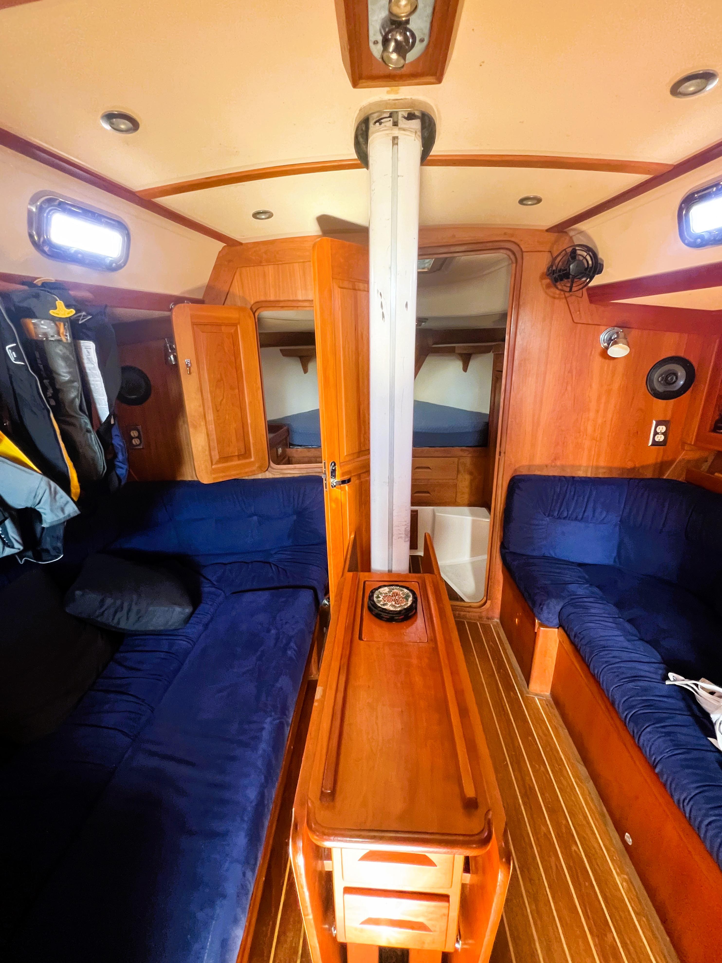 Interior of 2003 Tartan 4100 sailboat with wooden furnishings and blue seating.