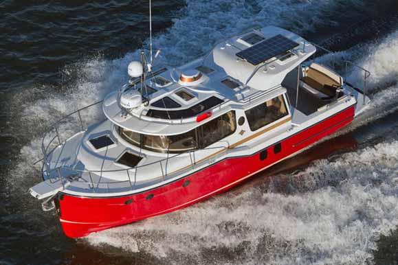 Manufacturer Provided Image: 2025 Ranger Tugs R-29 S cruising on water, featuring a vibrant red hull.