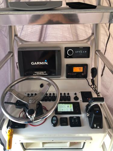The image shows the helm of an Andros 26 Tarpon boat with a Garmin navigation system.