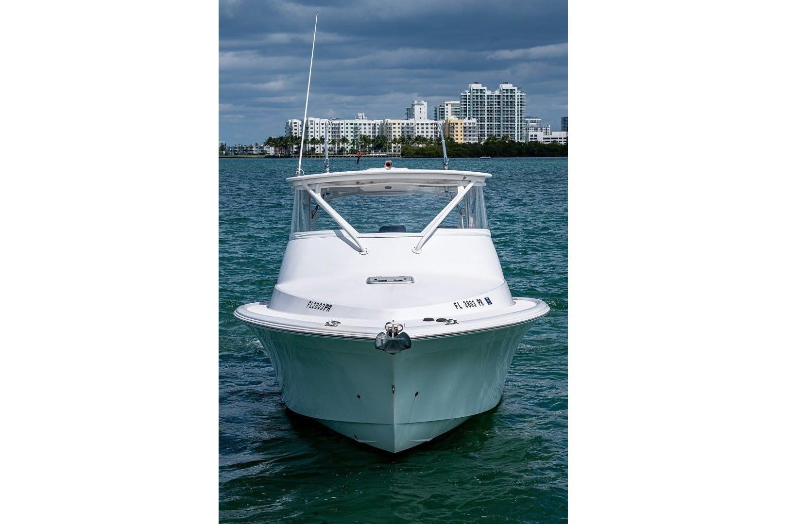 Front view of a 2012 Brooks Boatworks 34 on water, with city skyline background.