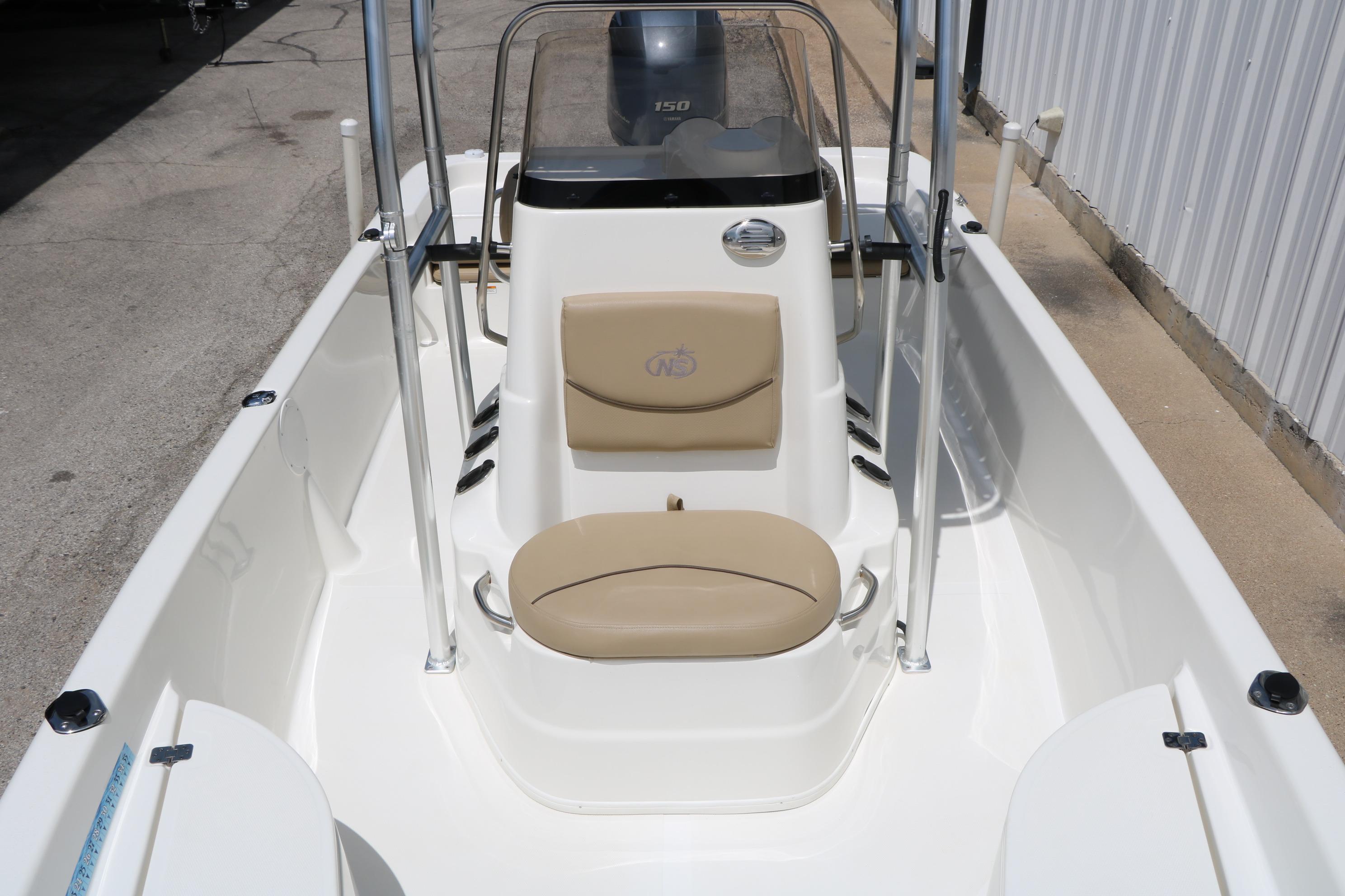 2020 NauticStar 2140 Sport boat interior with beige seating and console.