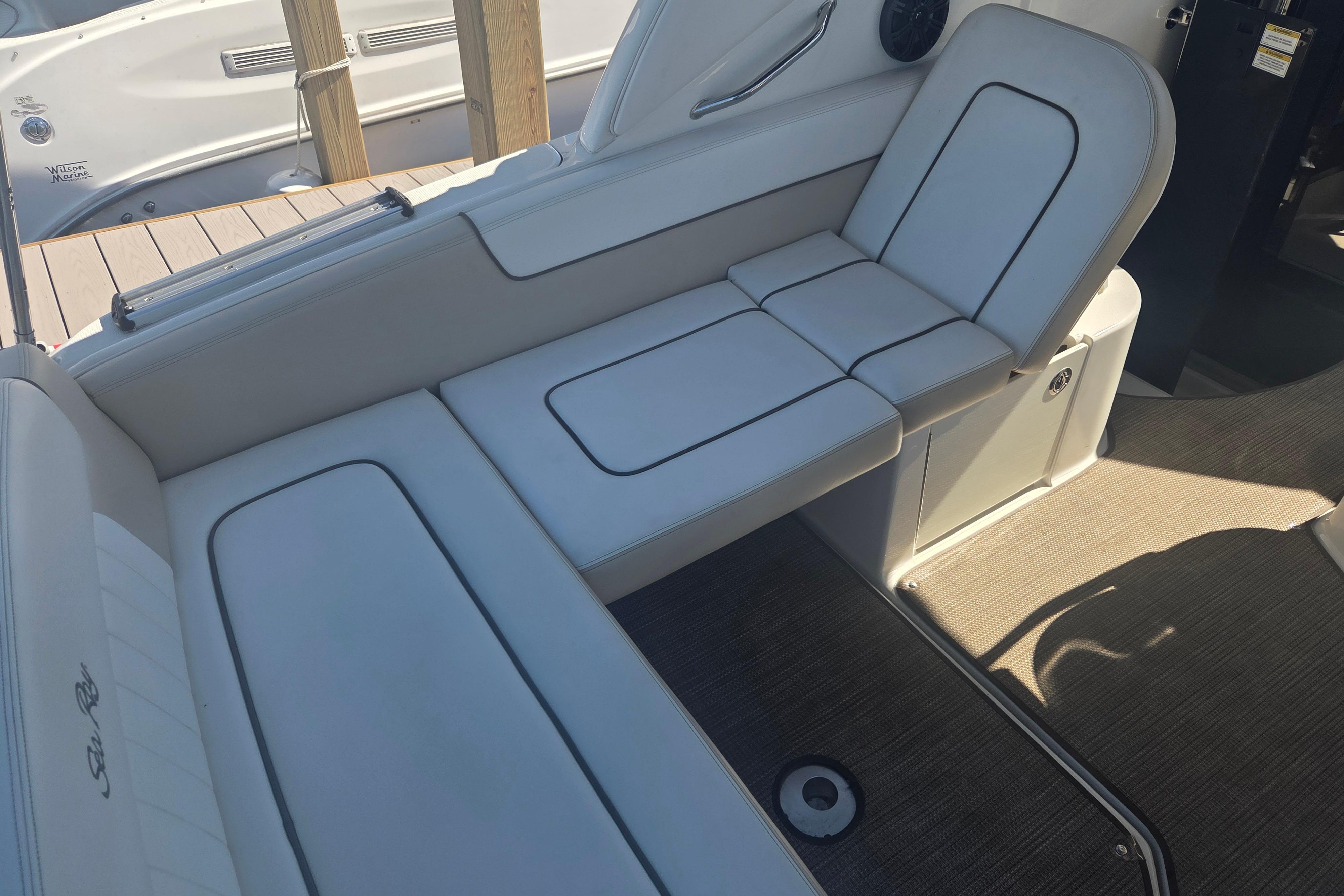 Interior seating of 2012 Sea Ray Sundancer 260 boat, featuring white cushioned seats.