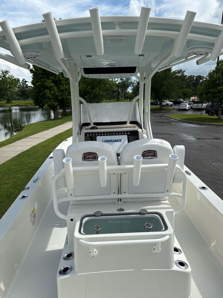 2025 Ranger 2360 Bay boat interior with rod holders and seating, near a lake.