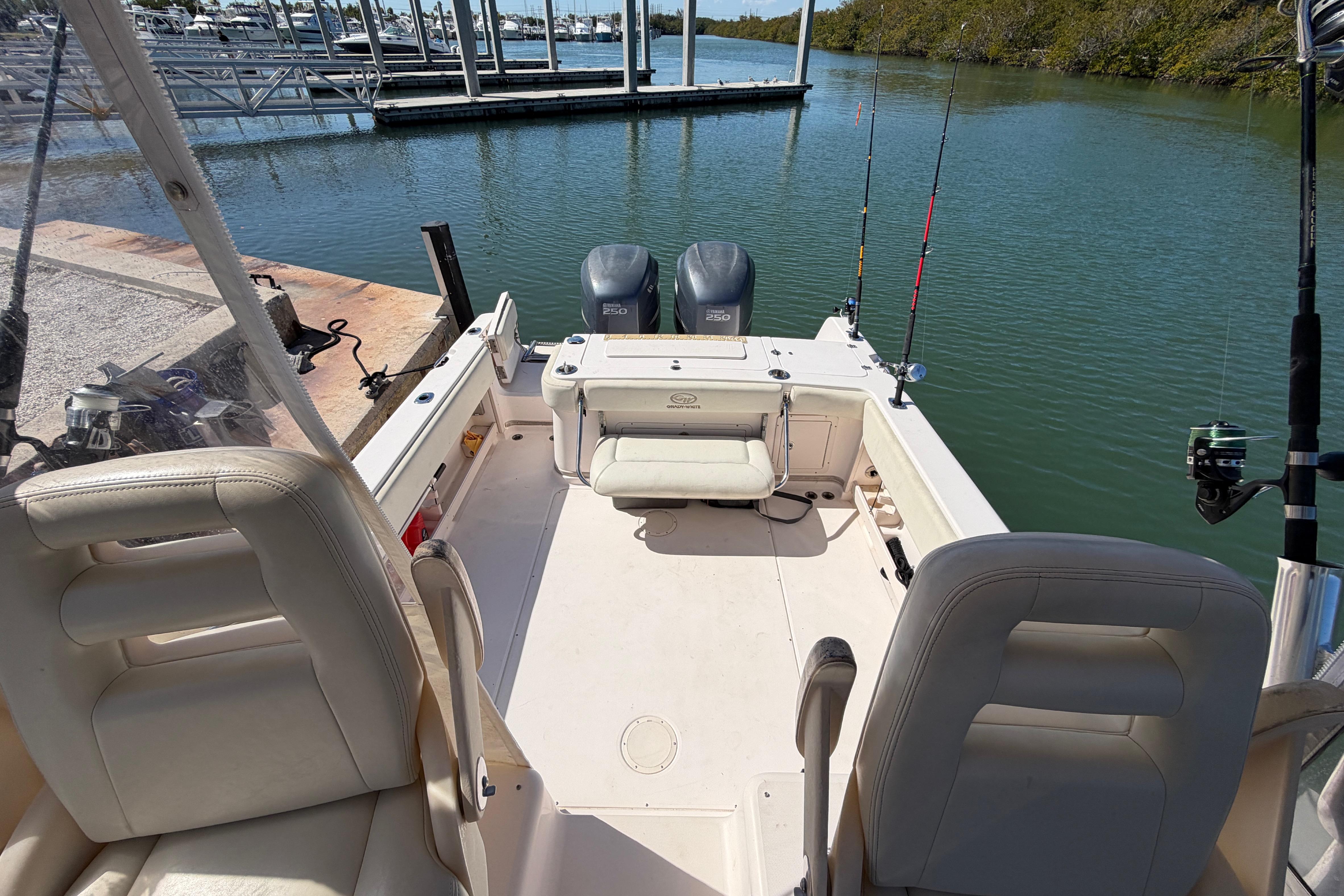 2006 Grady-White Sailfish 282 boat interior with fishing rods and dual engines.