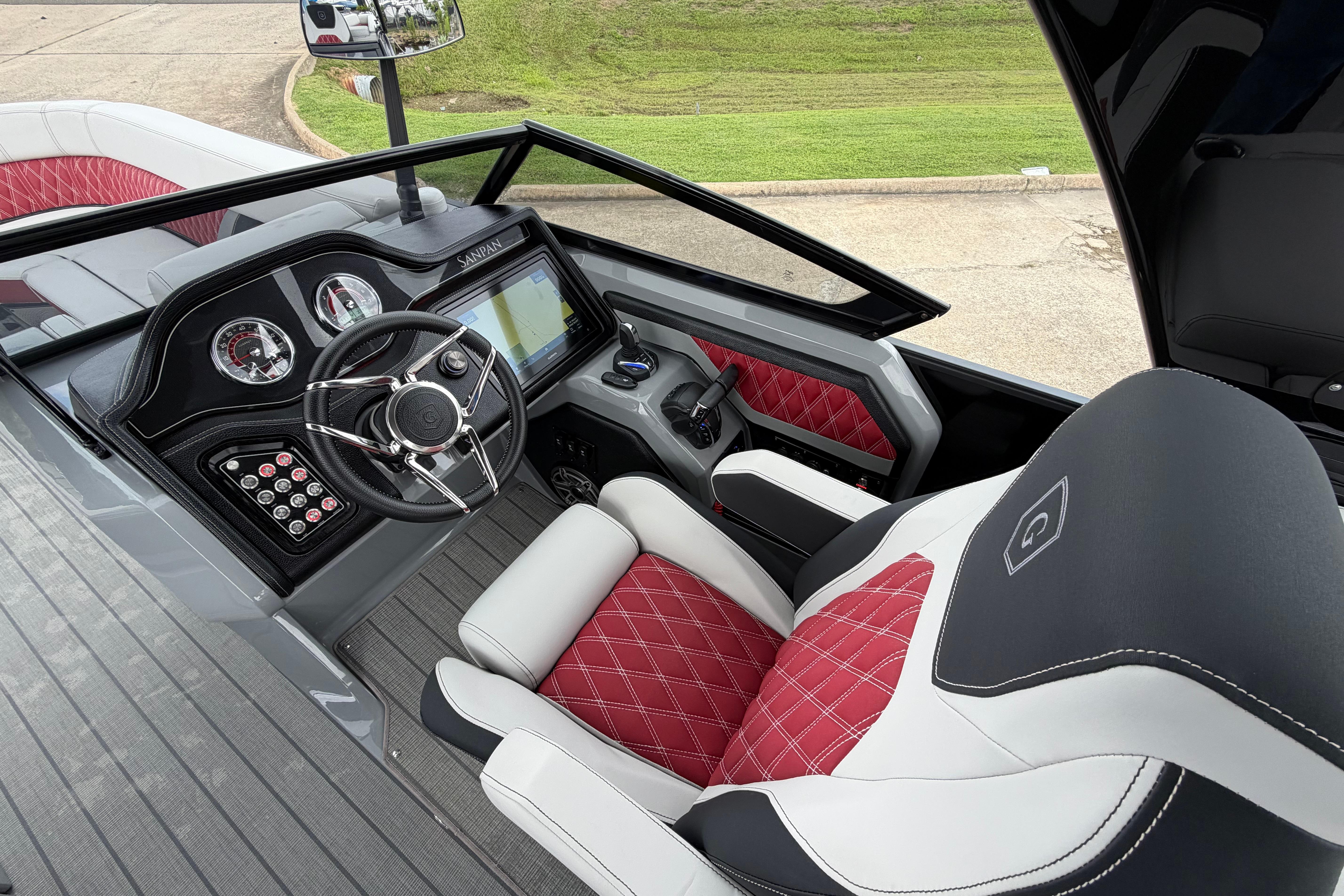 2023 Godfrey Sanpan 2700 ULW Twin boat interior with red and white seating, modern dashboard.