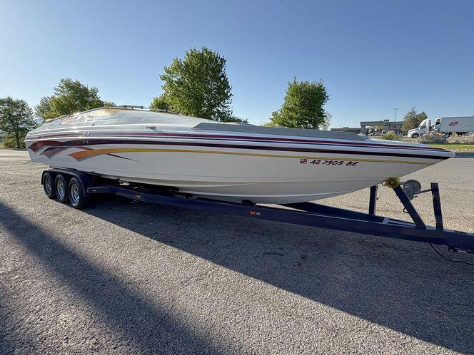 2002 Advantage Victory boat on trailer, parked outdoors, with trees in the background.