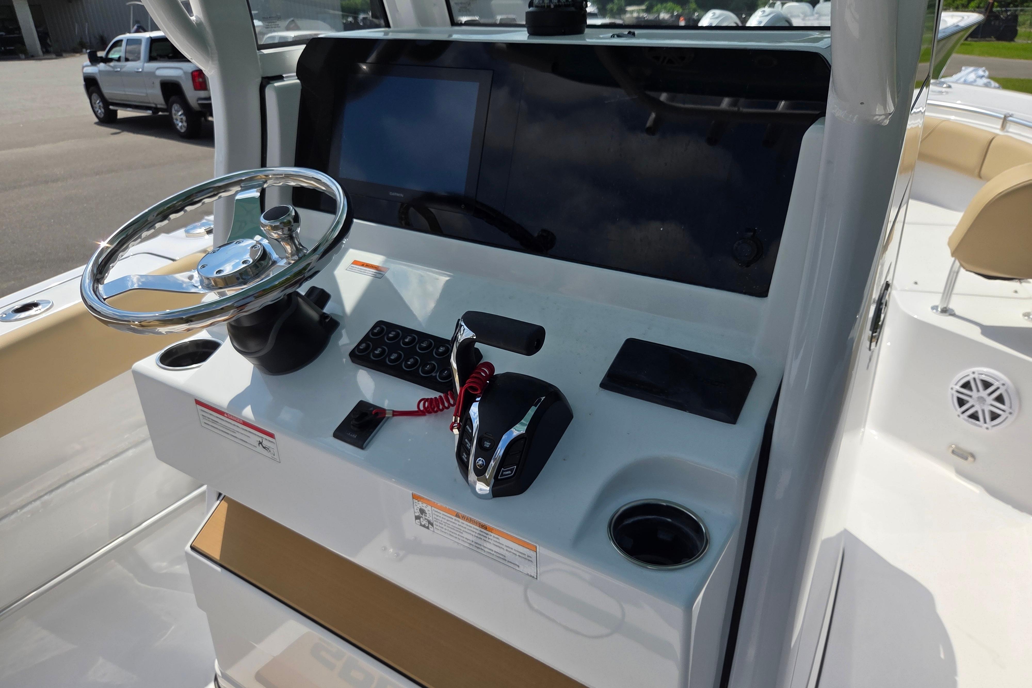 Center console of 2026 Sportsman Open 232 boat with steering wheel and controls.