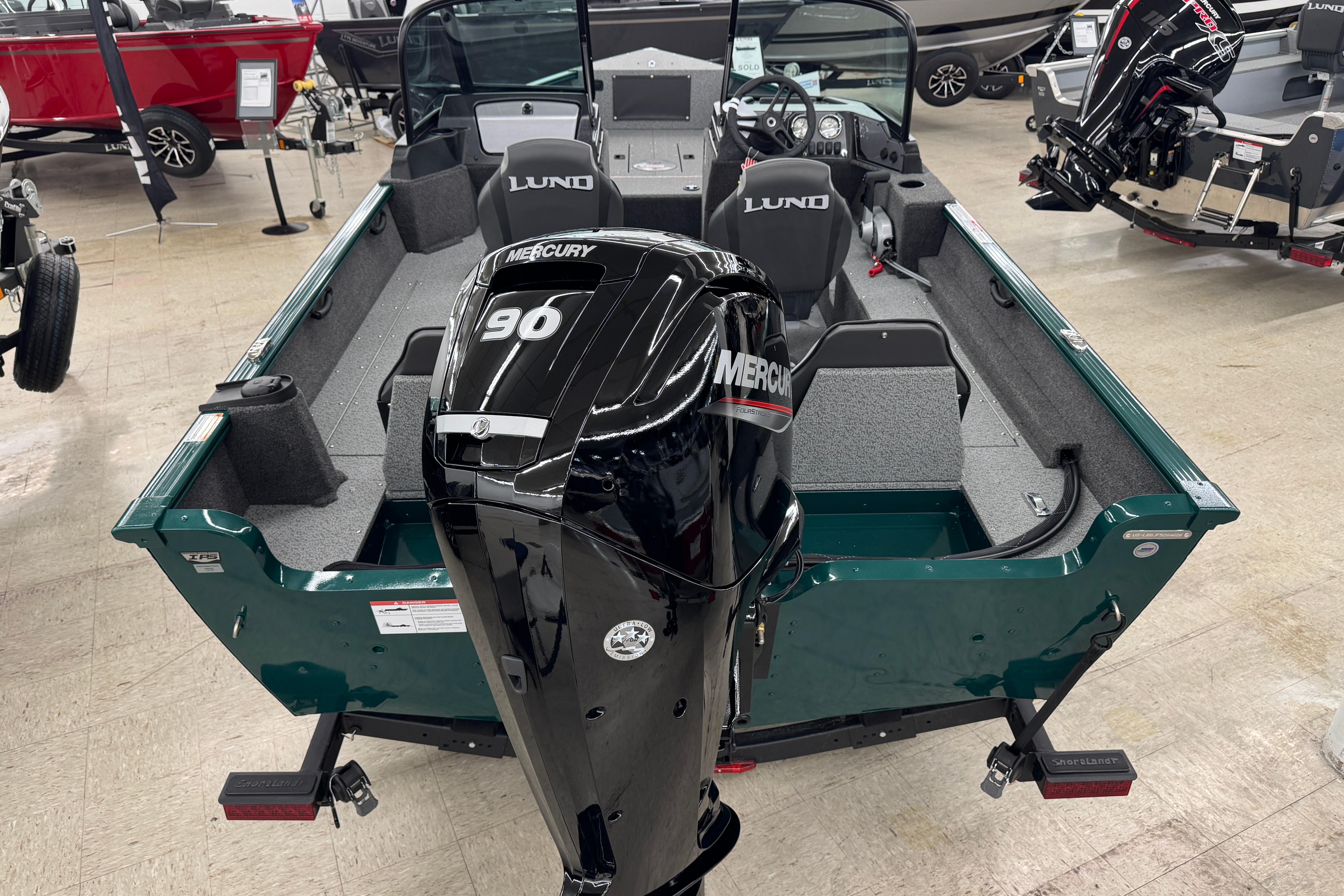 2026 Lund 1650 Rebel XL Sport boat with Mercury 90 engine in showroom.