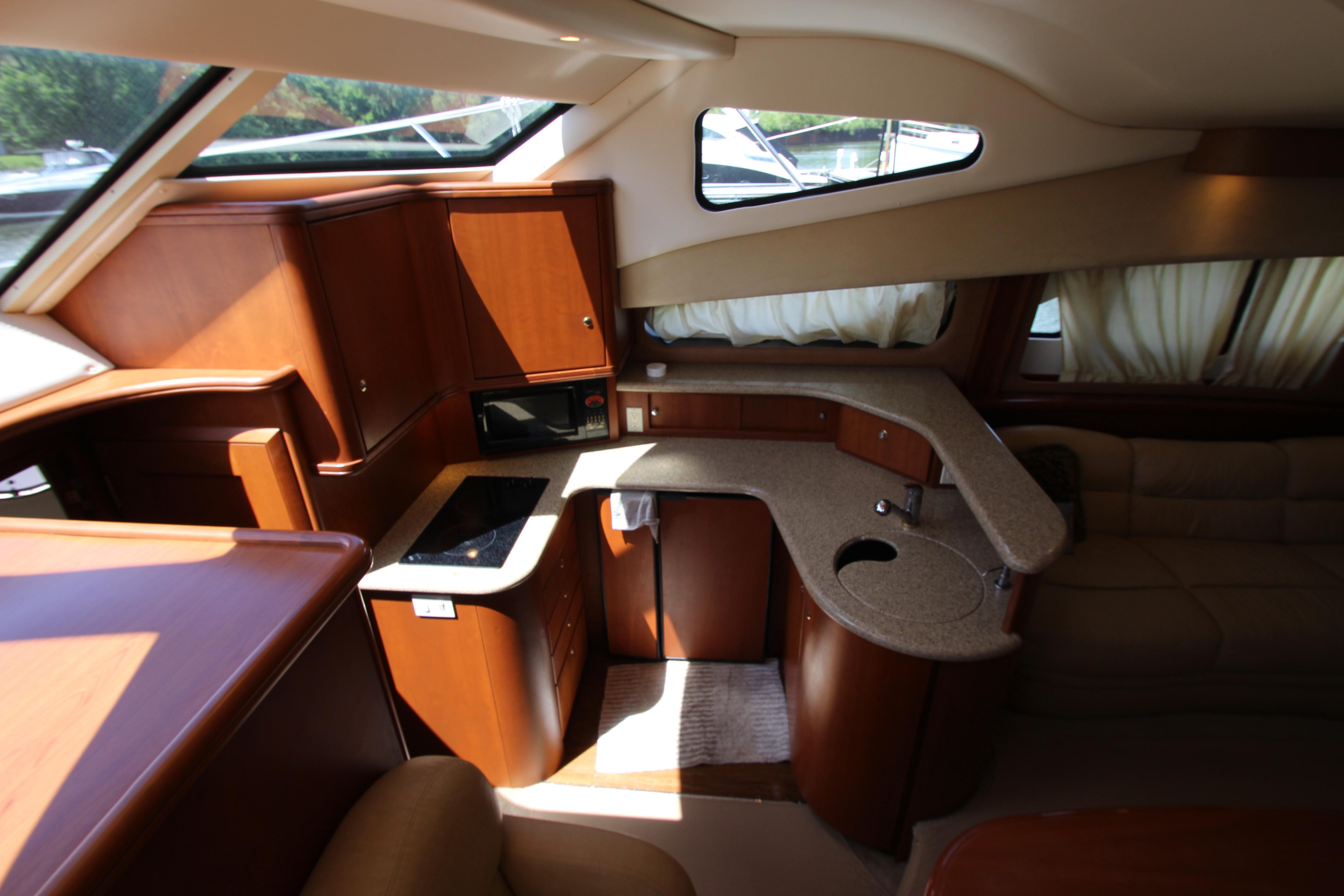 Luxurious interior of 2006 Silverton 38 Sport Bridge yacht with modern kitchen amenities.