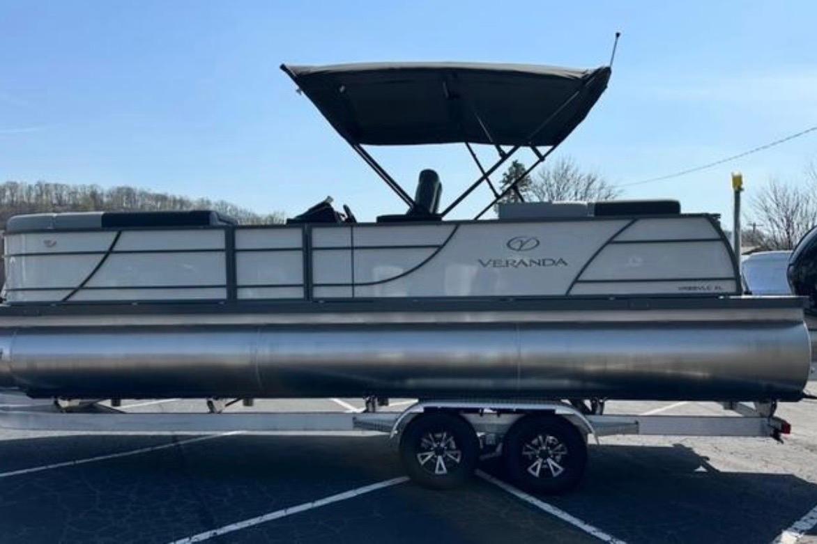2025 Veranda Relax VR25VLC pontoon boat on trailer, parked outdoors.