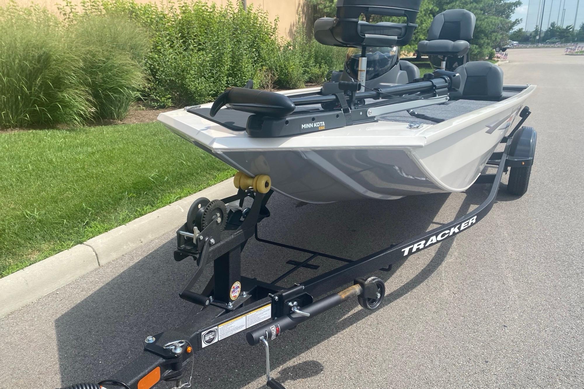 2026 Tracker Pro 170 boat on trailer, parked on a paved road.