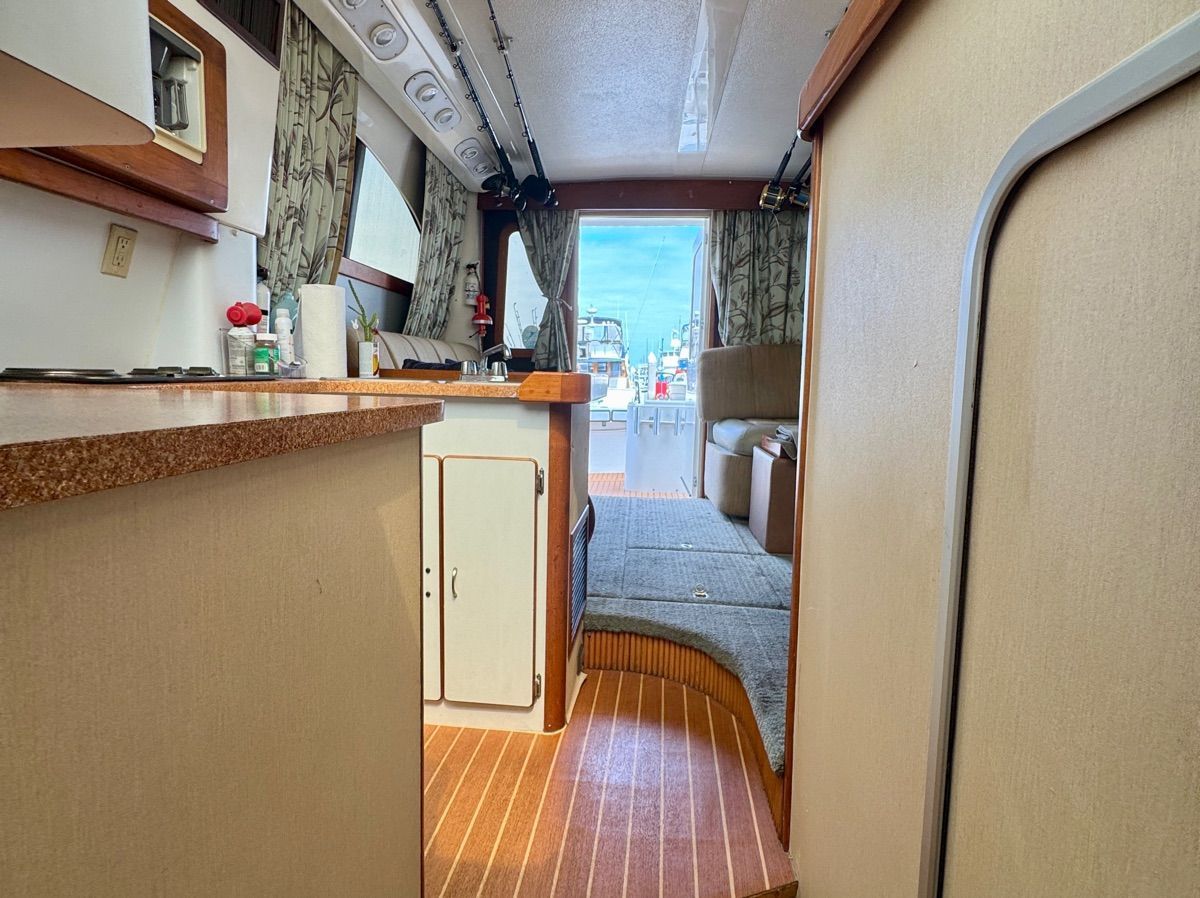 Interior view of a 1989 Luhrs 350 Tournament with kitchen and seating area.