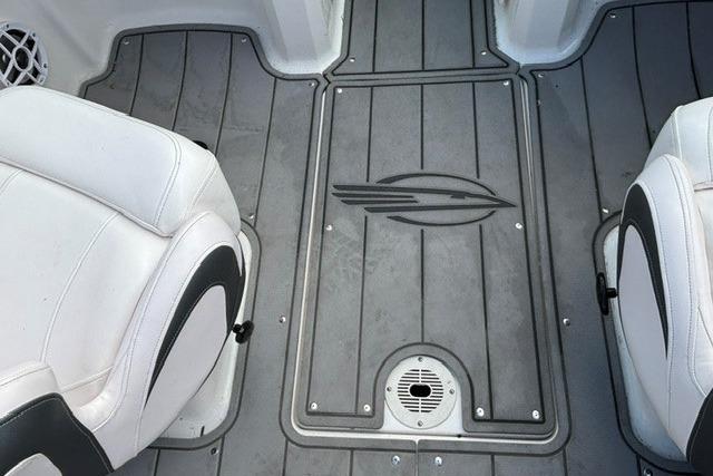 Interior view of 2021 Chaparral 21 SSi boat with gray flooring and white seats.
