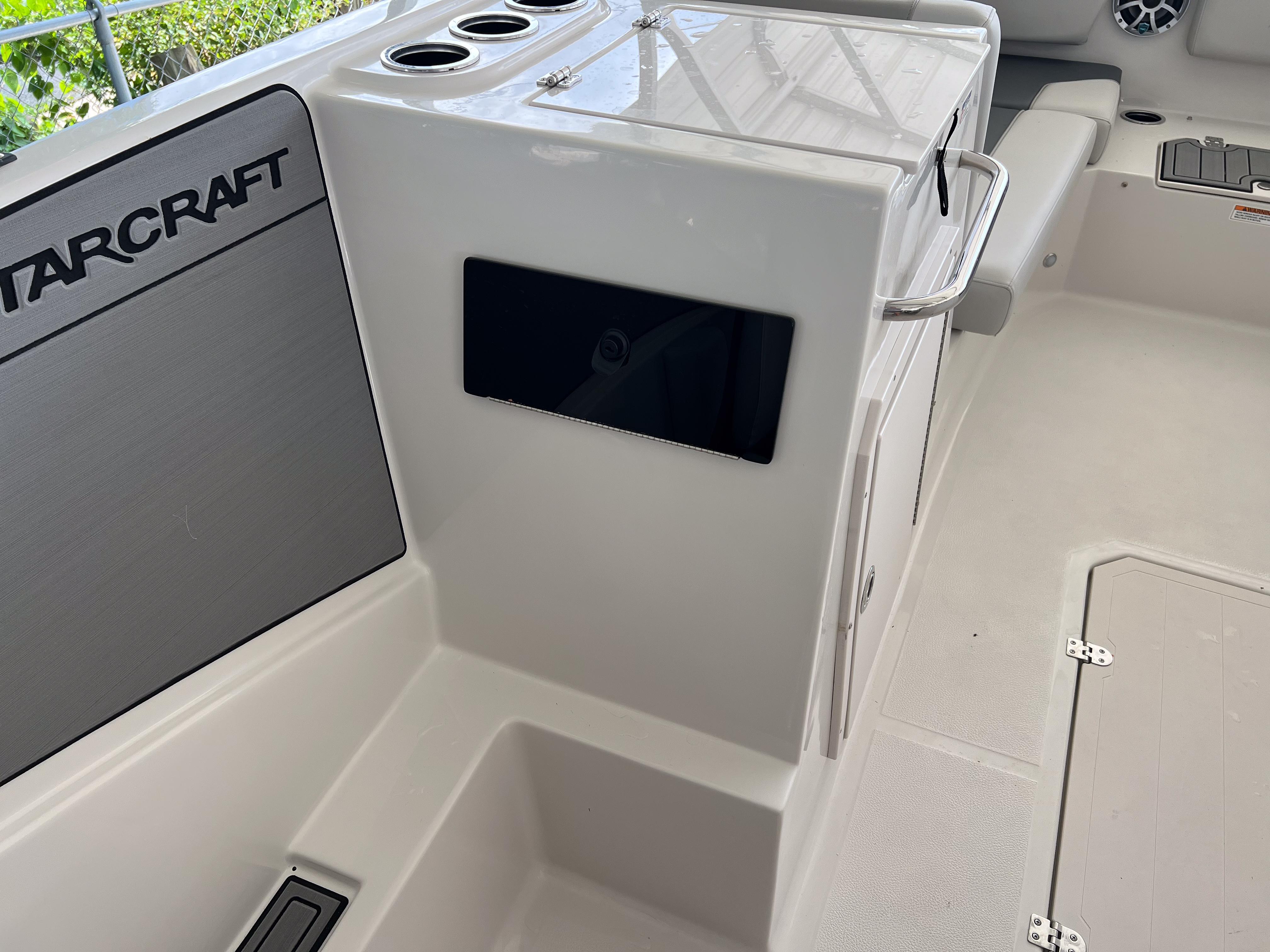 Interior of 2026 Starcraft SVX 231 OB boat, featuring seating and storage compartments.