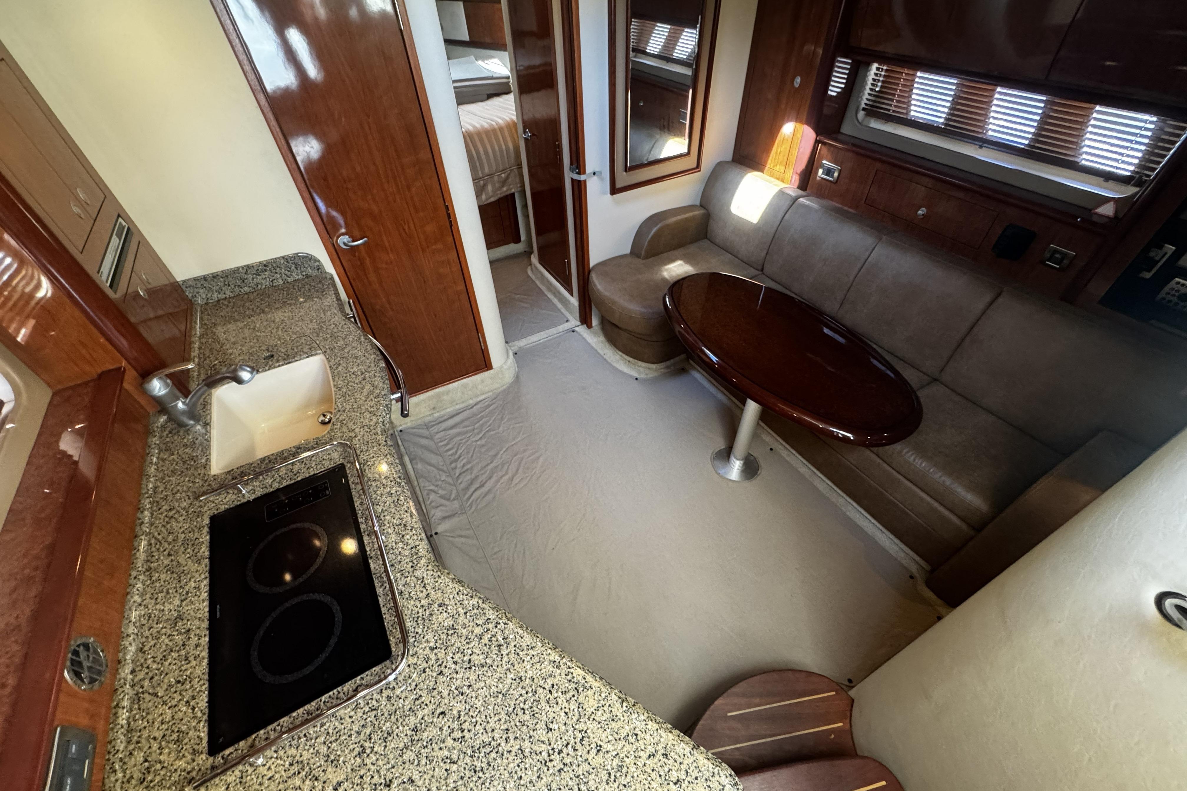 Interior of 2006 Sea Ray 40 Sundancer yacht with kitchen and seating area.