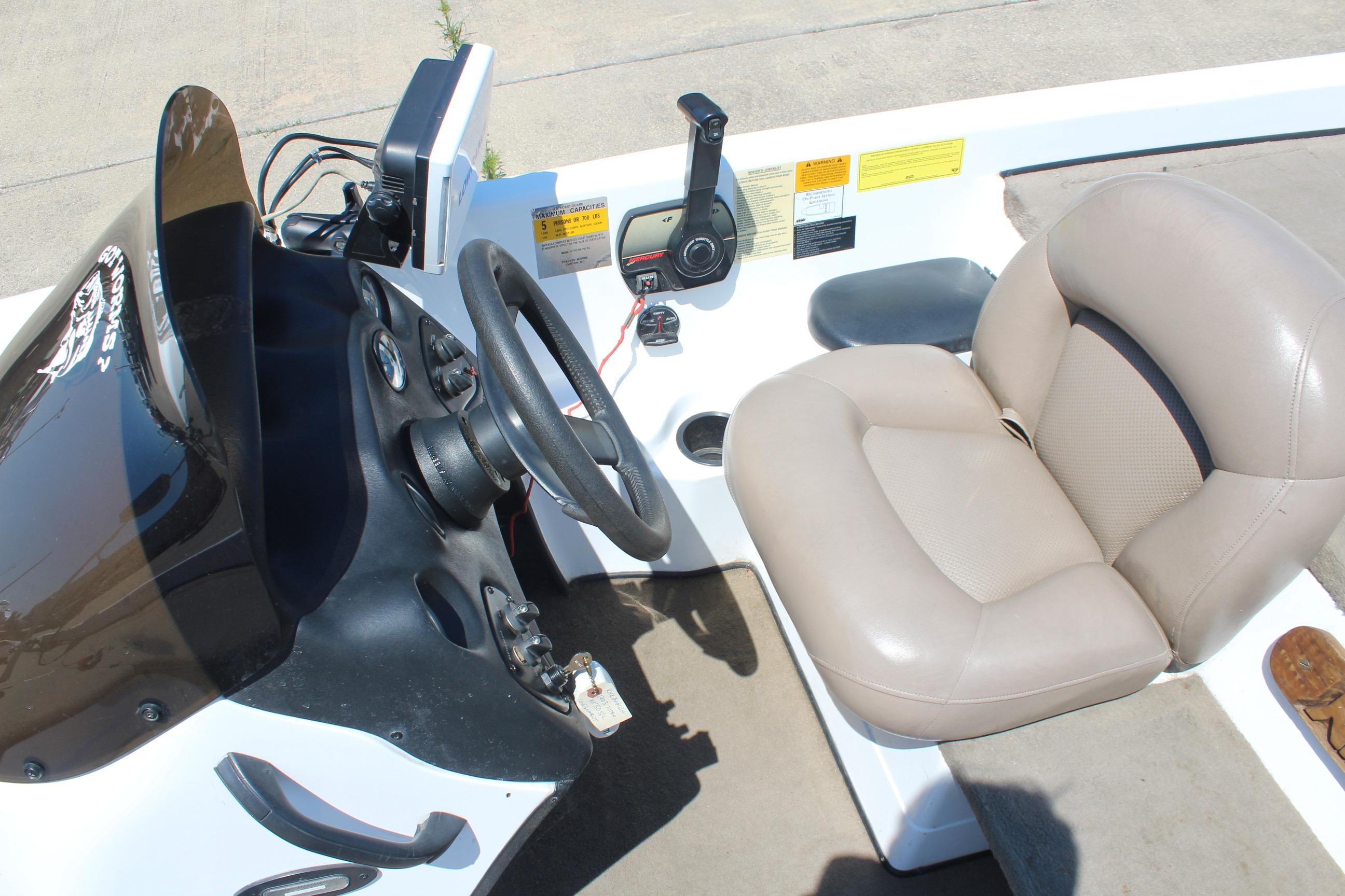 2003 Nitro NX 750 SC boat cockpit with steering wheel and beige seat.