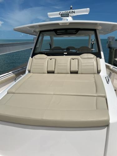 2019 Pursuit S 408 Sport boat with beige seating, Garmin radar, and ocean backdrop.