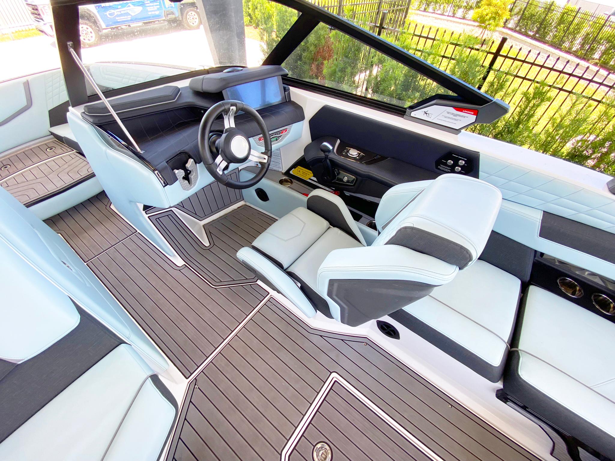 2024 Nautique Super Air Nautique G21 interior with modern helm and seating.