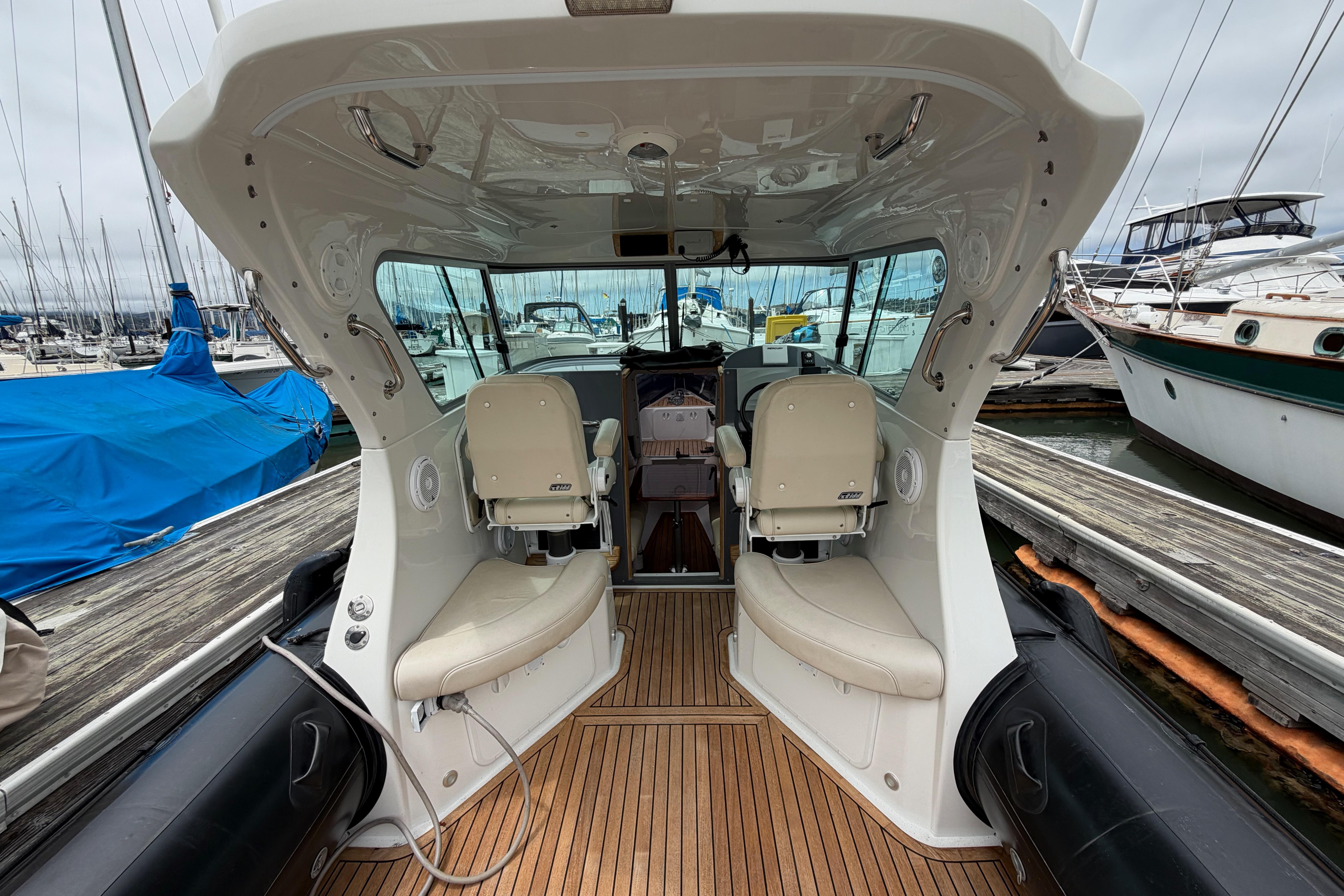 2016 Protector Targa 30 boat interior with seating, docked at marina.