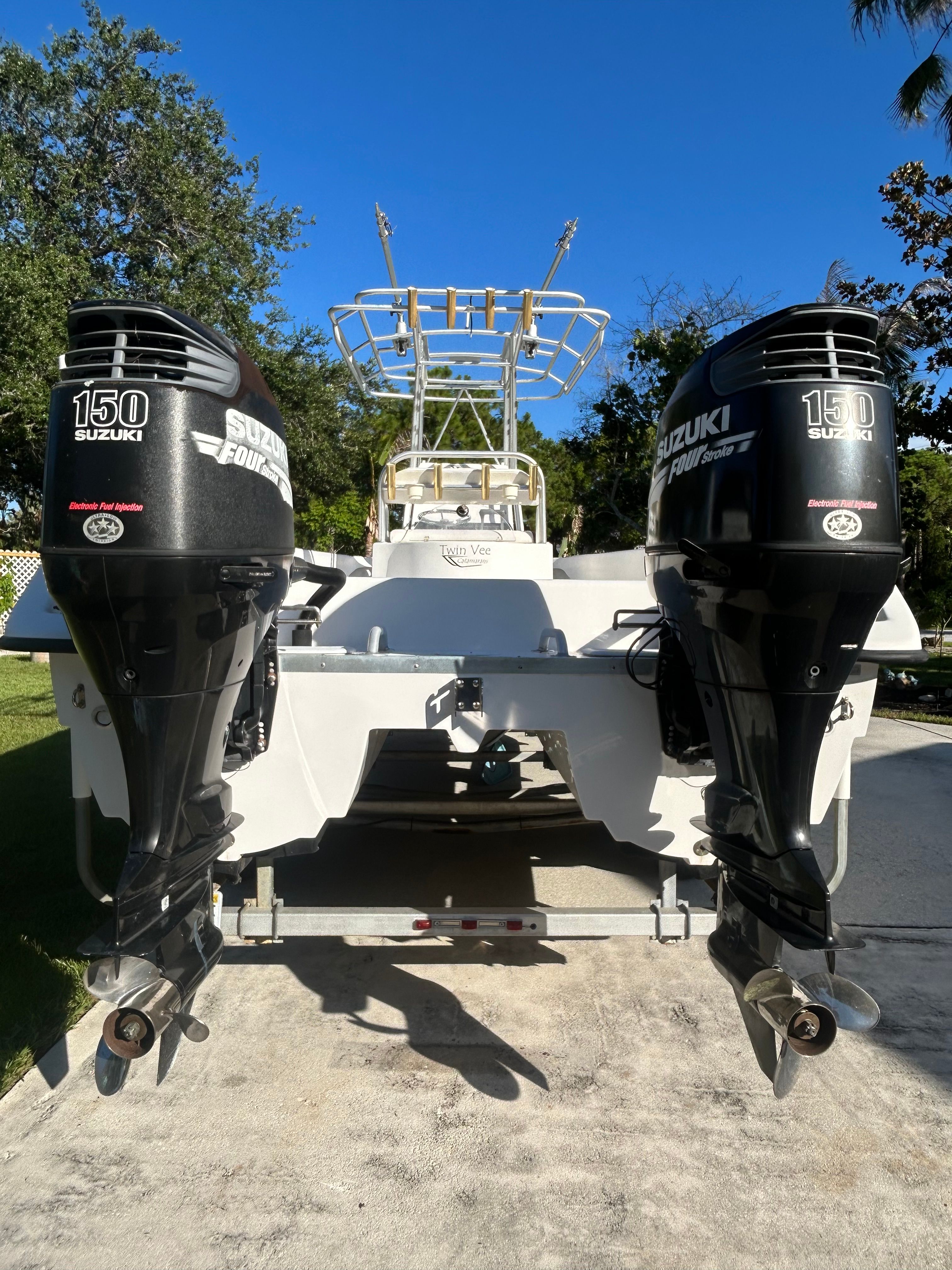 Two Suzuki 150 HP outboard engines are mounted on a 2007 Twin Vee 26 Center Console boat.