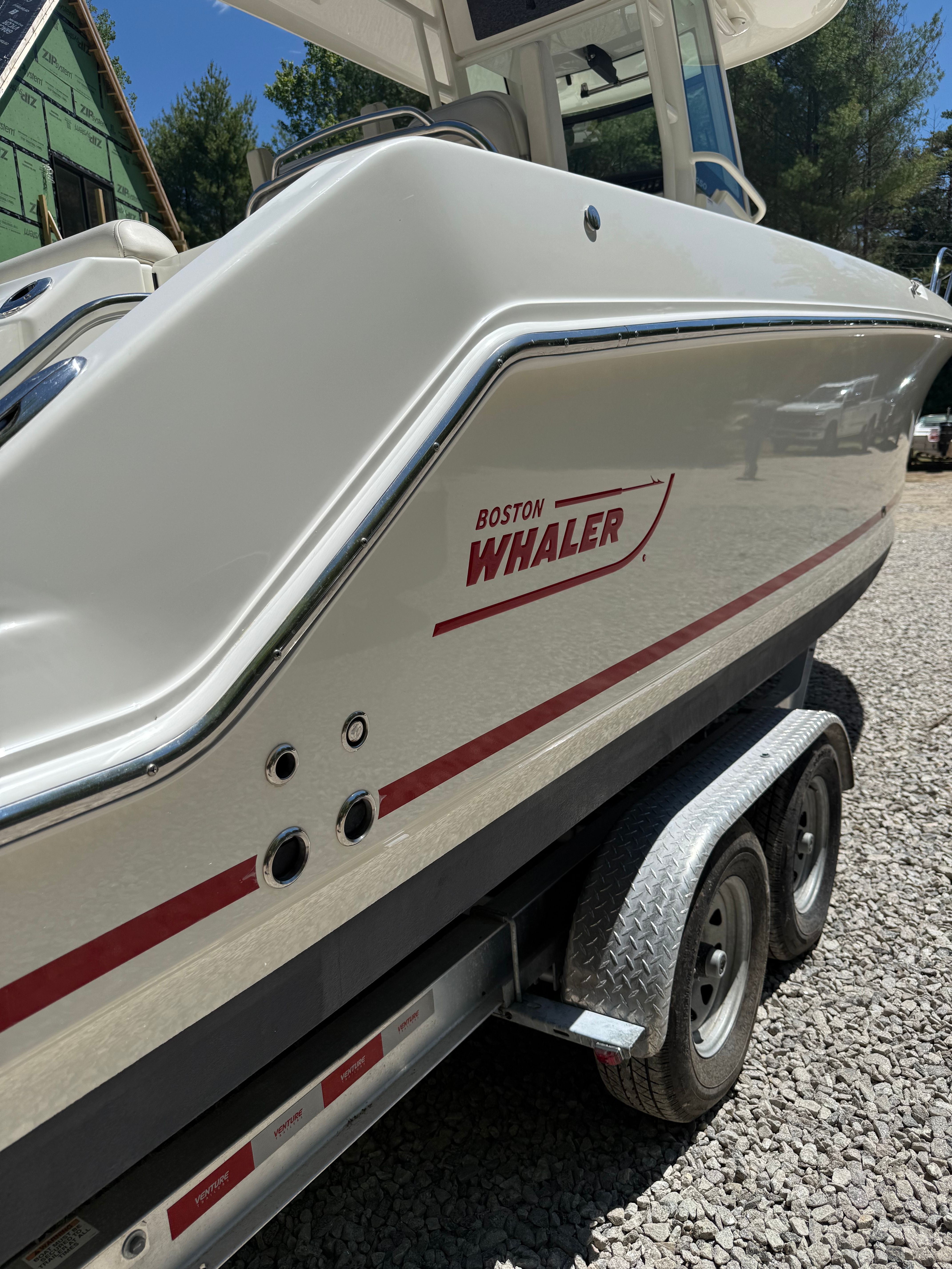 2024 Boston Whaler 250 Outrage on trailer, side view.