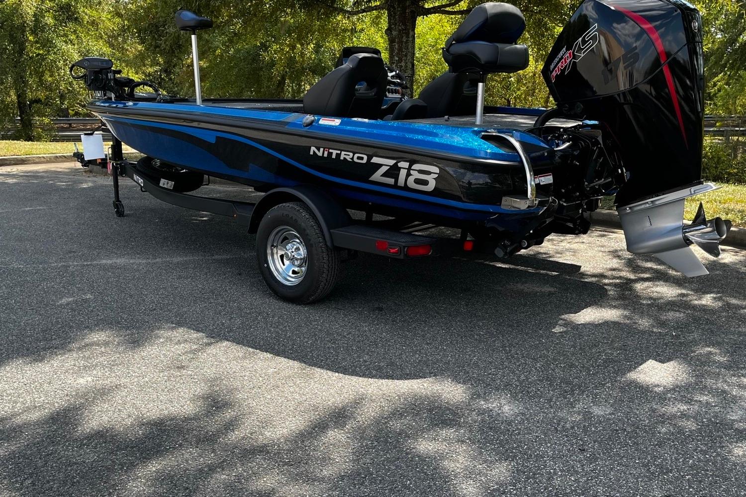 2025 Nitro Z18 boat in blue, parked outdoors, showcasing sleek design and powerful engine.