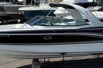 2015 Formula 310 Bowrider boat in marina, sleek design, black and white exterior.