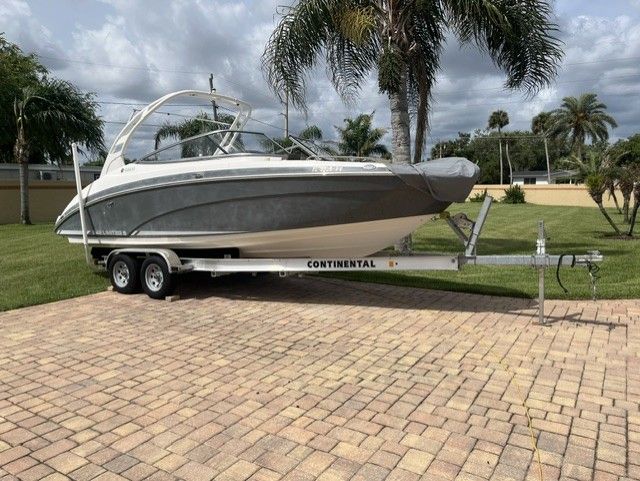 2015 Yamaha Boats 242 Limited S on trailer, palm trees in background.