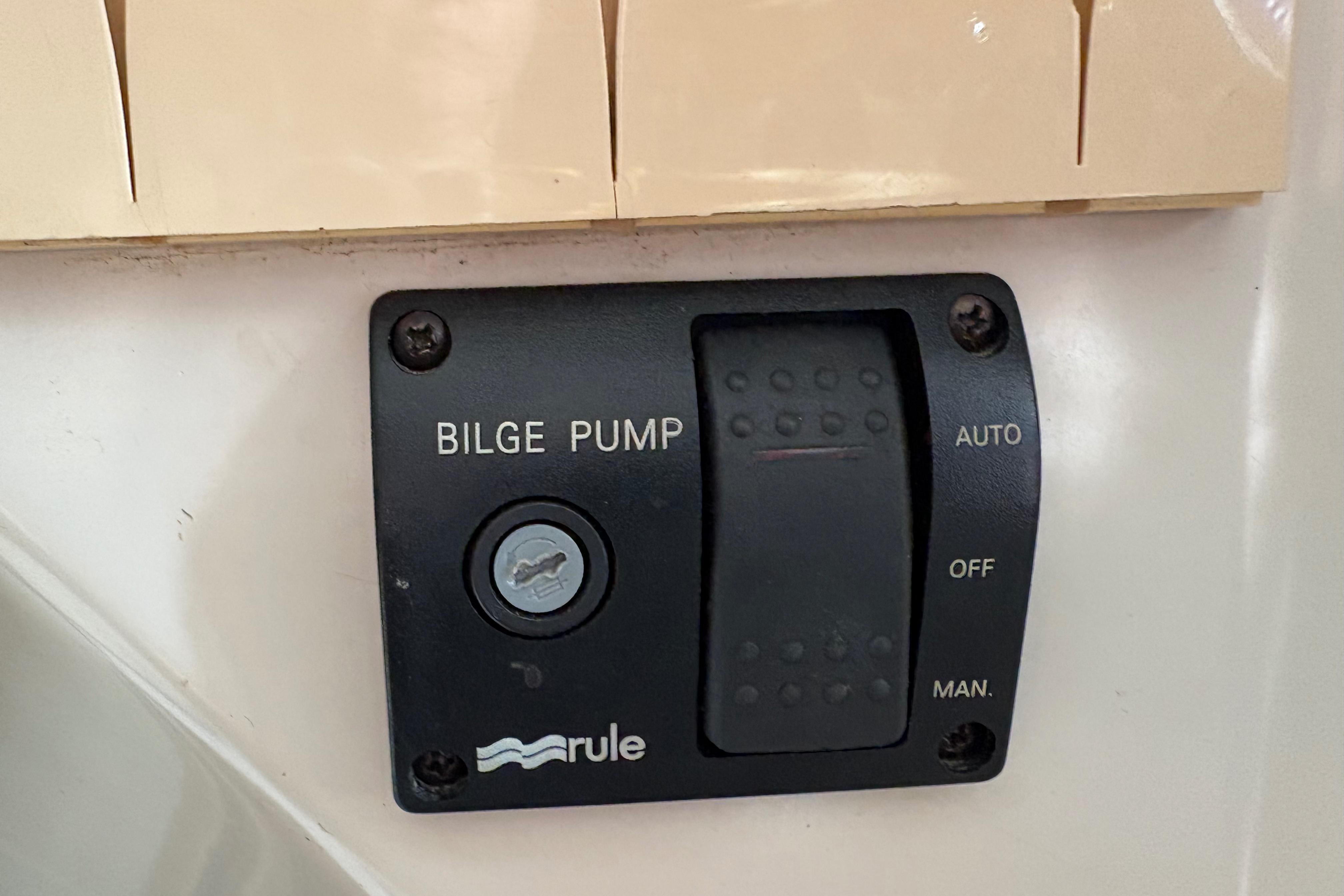 Bilge pump control panel on 1981 Sabre 31 boat, featuring auto, off, and manual settings.