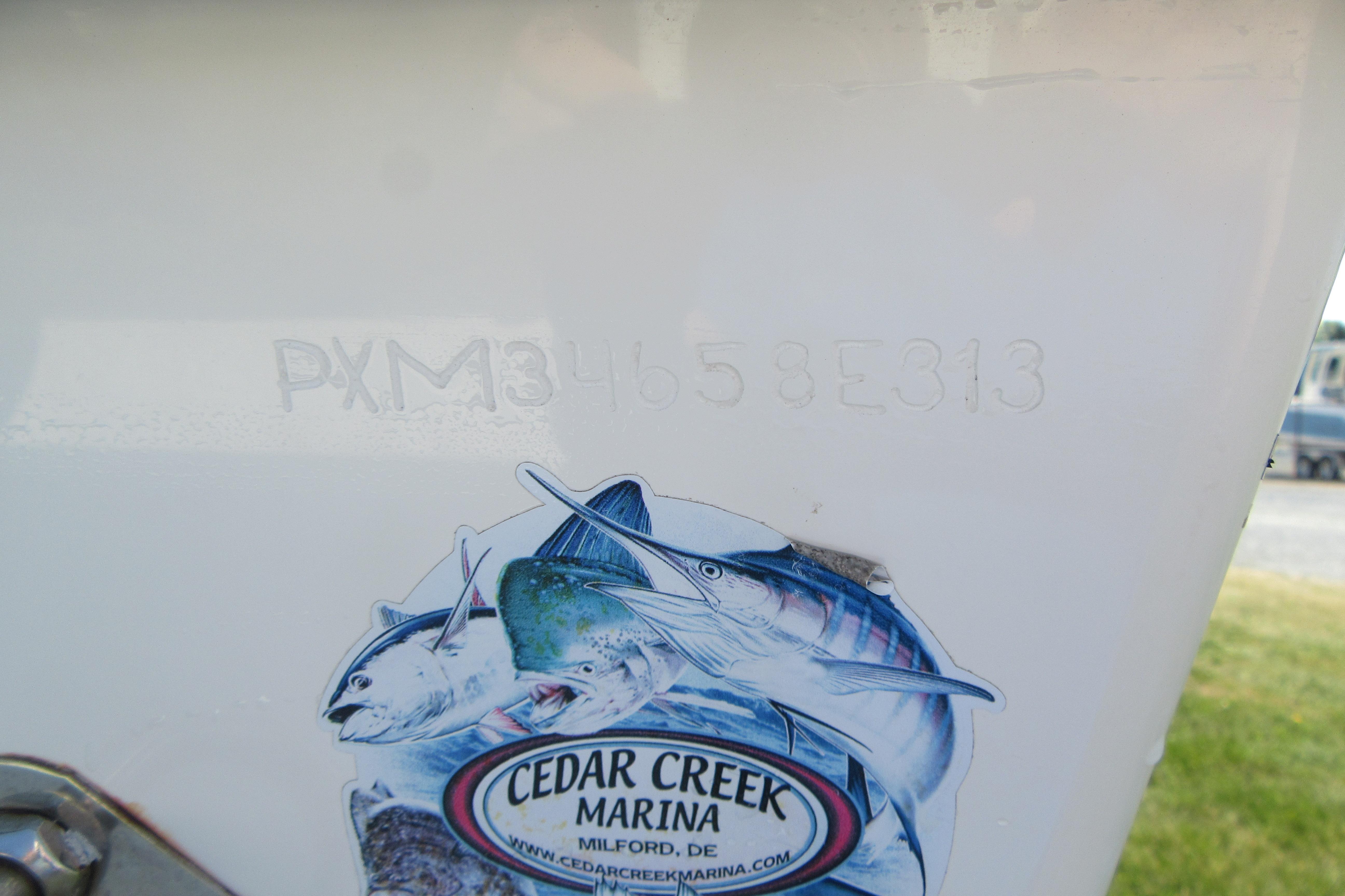 Hull identification number on 2013 Parker 2320 SL Sport Cabin boat with Cedar Creek Marina sticker.