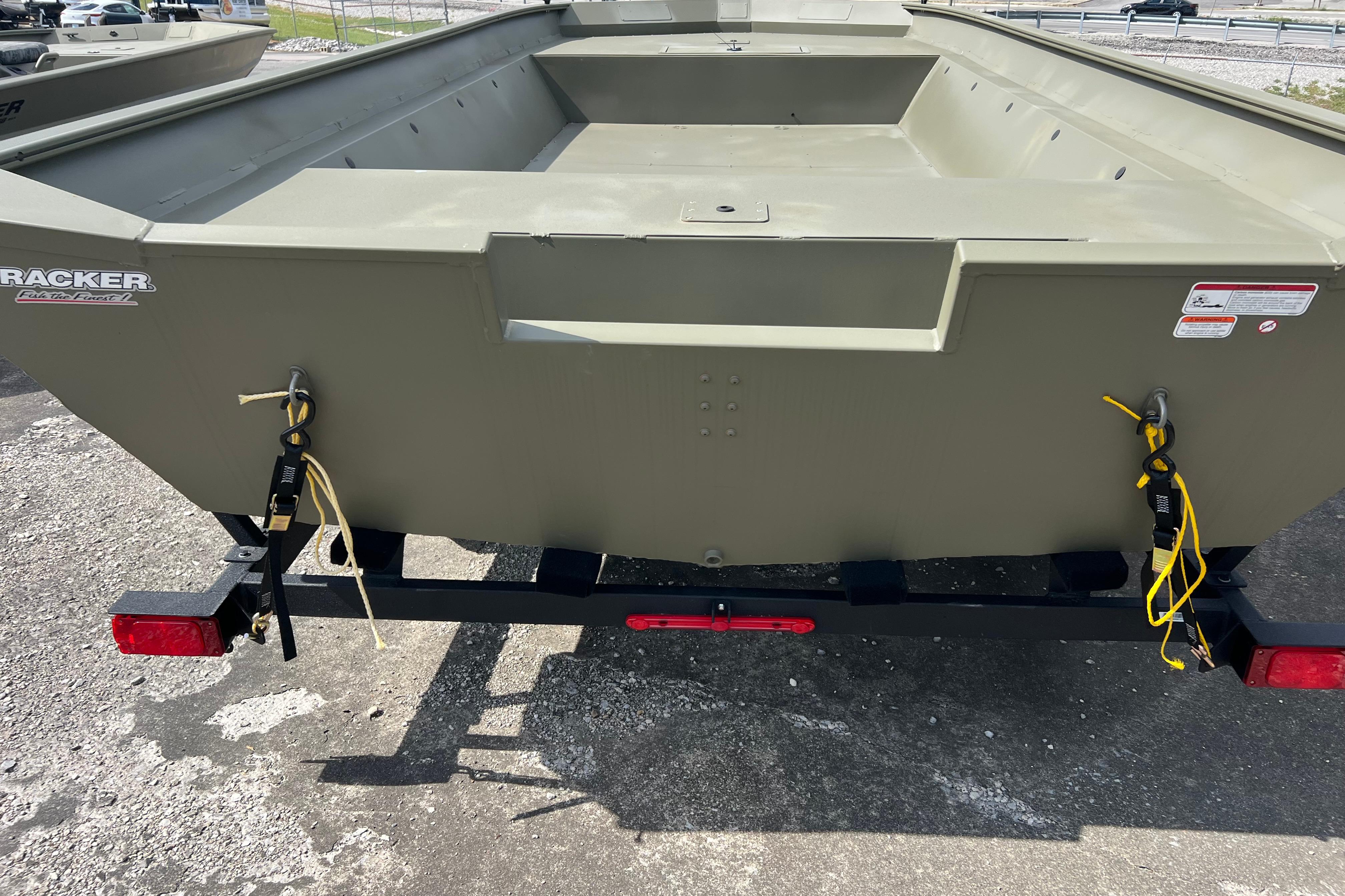 2025 Tracker Grizzly 2072 Utility boat on trailer, rear view, outdoors.