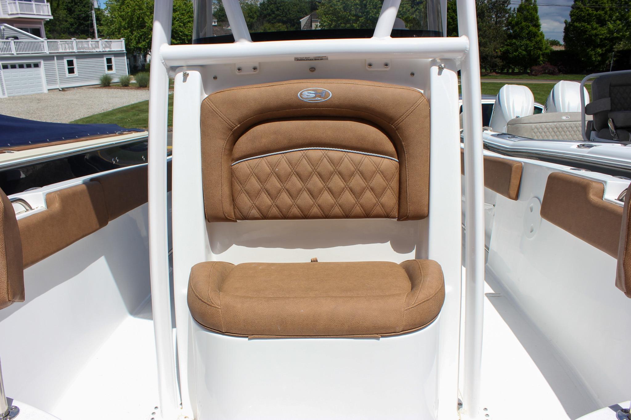2027 Sea Hunt Ultra 234 boat with tan cushioned seating and sleek white interior.