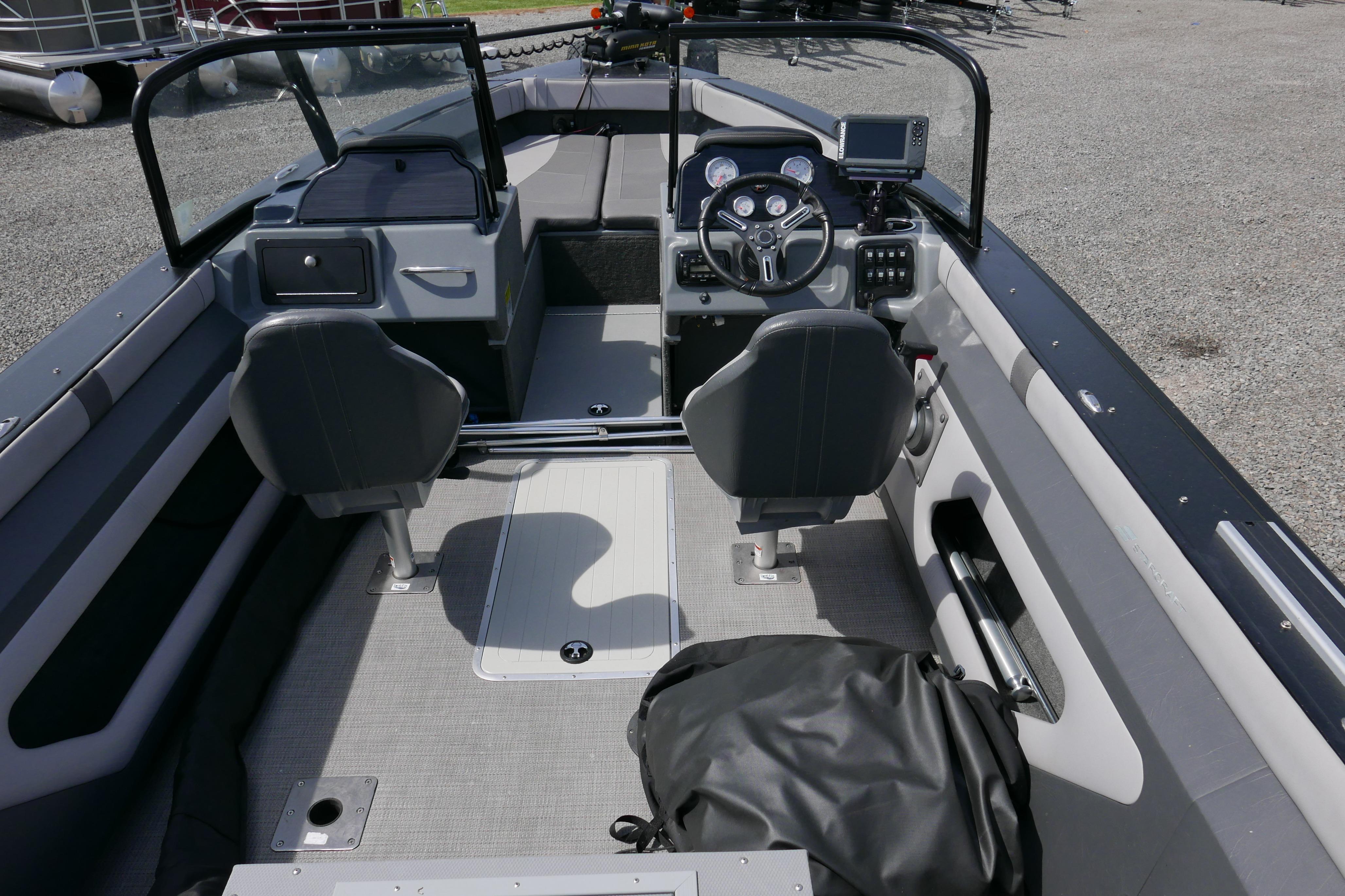 2016 Starcraft Titan 186 boat interior with steering console and seating.