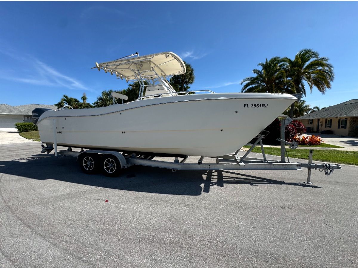 2004 World Cat 270TE boat on trailer, sunny day.