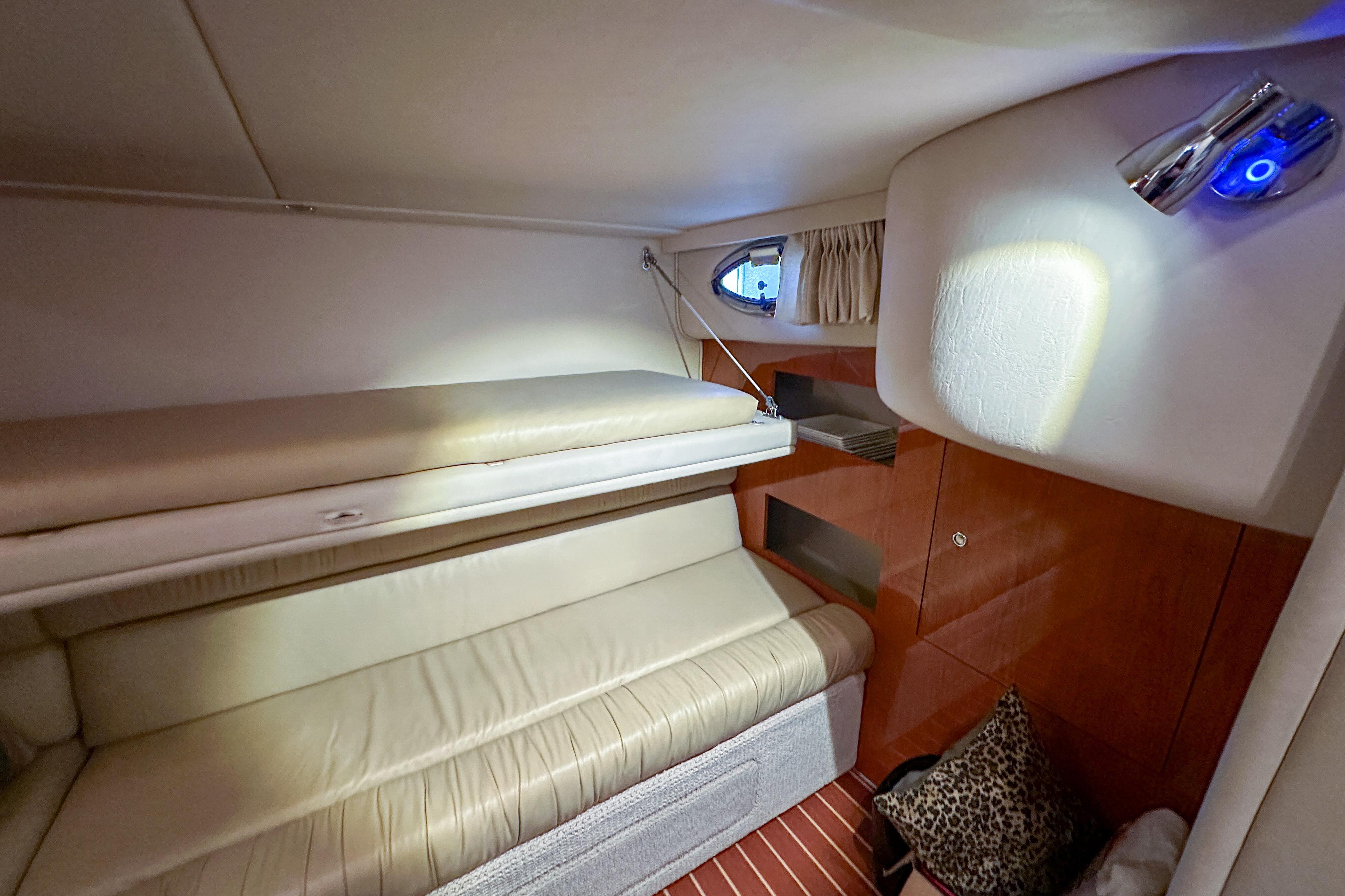 Interior cabin of 2001 Sea Ray 410 Sundancer with cozy seating and ambient lighting.