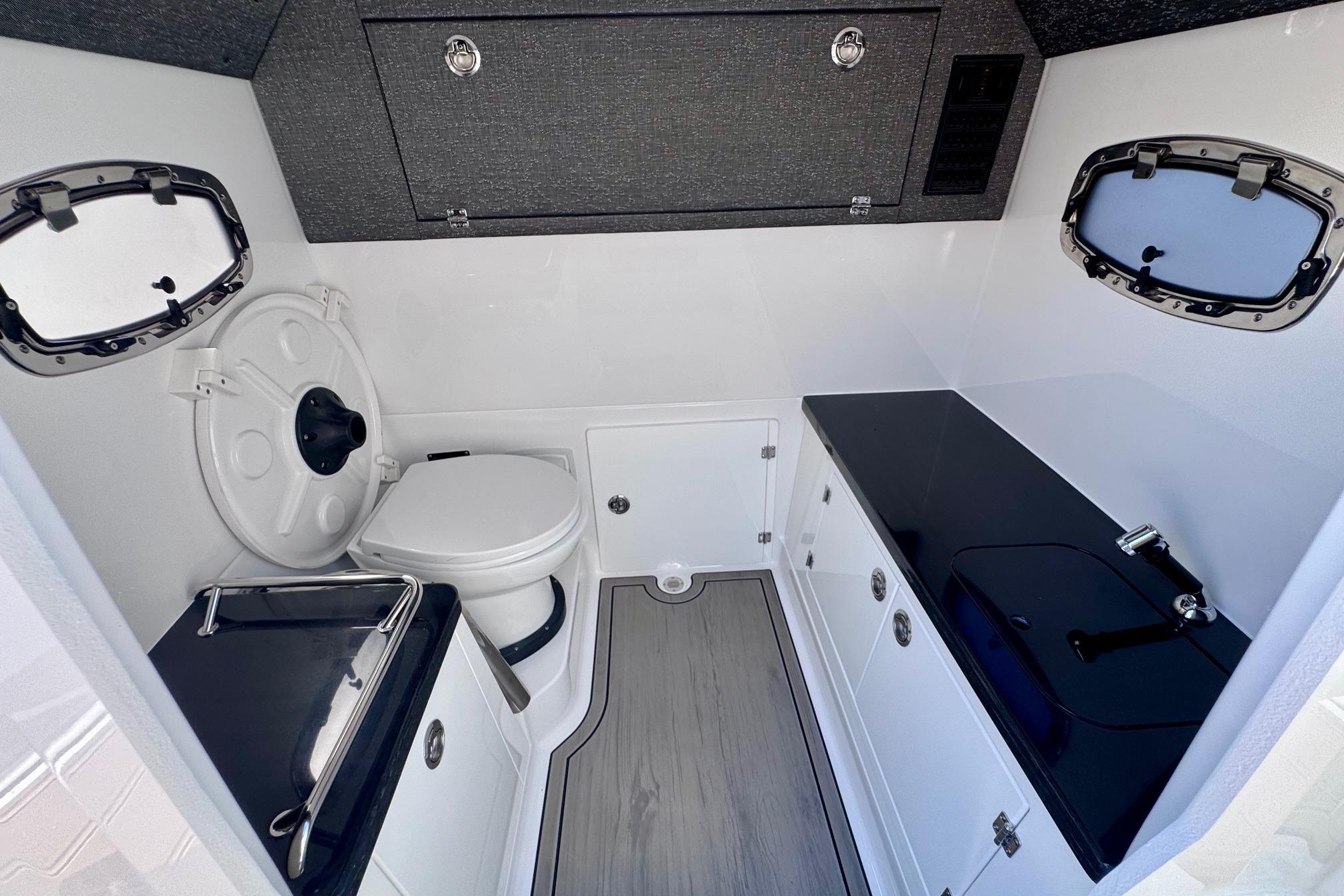 2026 Monterey Elite 27 OB boat interior with modern bathroom amenities.