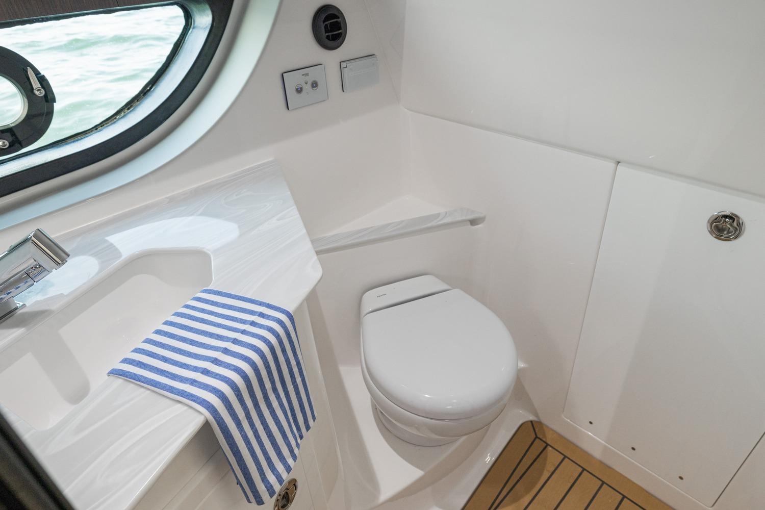 Luxurious bathroom in 2026 Hurricane SunDeck 3200 OB boat with modern fixtures.