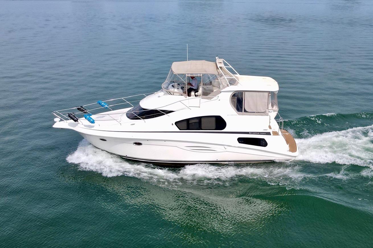 2004 Silverton 39 Motor Yacht cruising on calm waters.