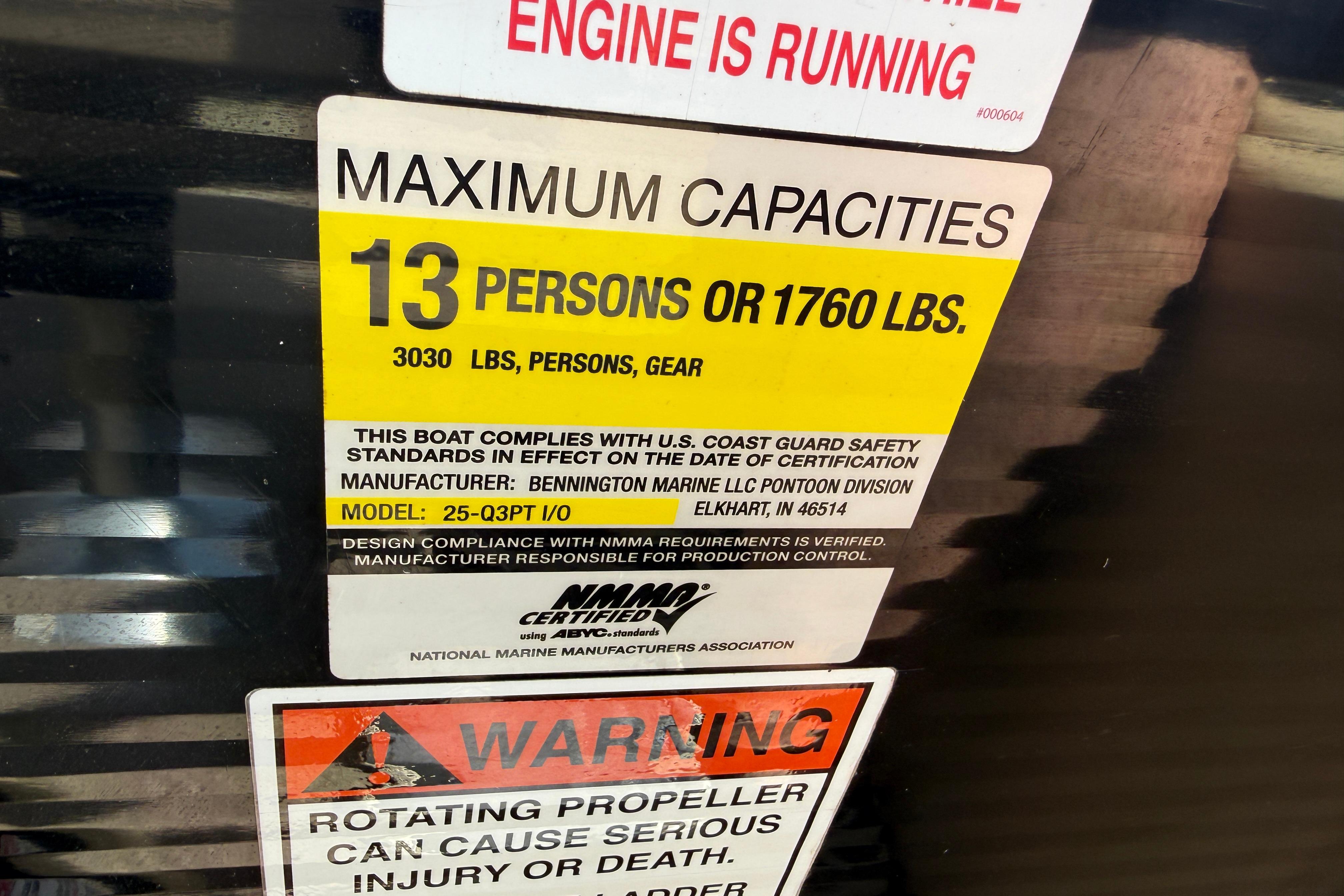 2011 Bennington 2575QCW I/O capacity label: 13 persons or 1760 lbs, safety compliance.