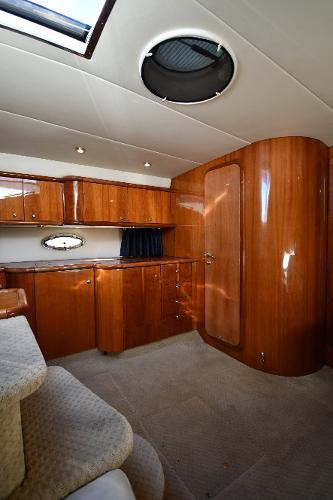 Luxurious interior of a 1997 Sunseeker Camargue 47 yacht with polished wood cabinetry.