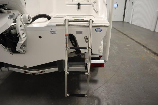 2025 Sea Fox 228 Commander boat with rear ladder in a garage setting.