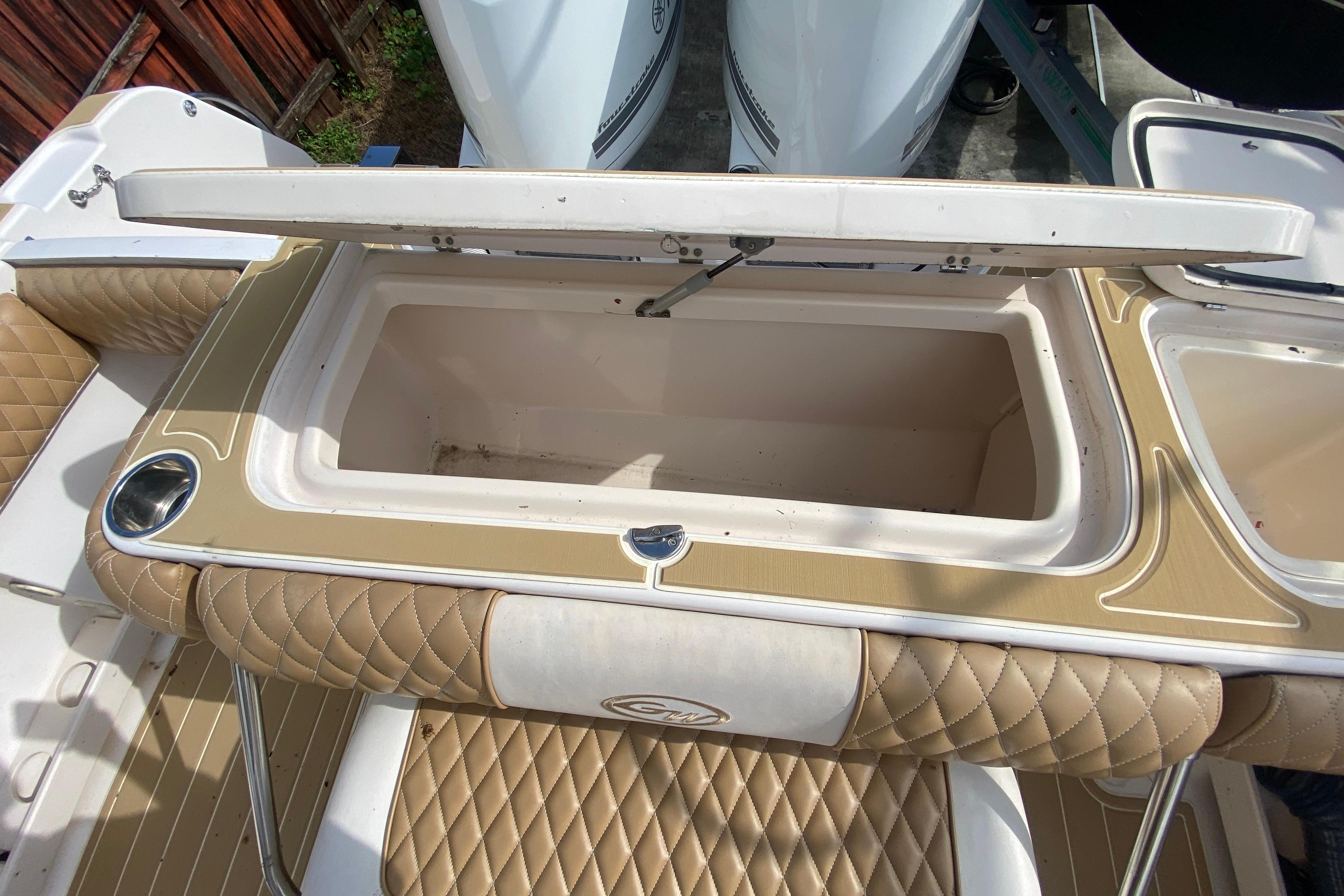 Open storage compartment on 2004 Grady-White Canyon 283 boat with quilted seating.