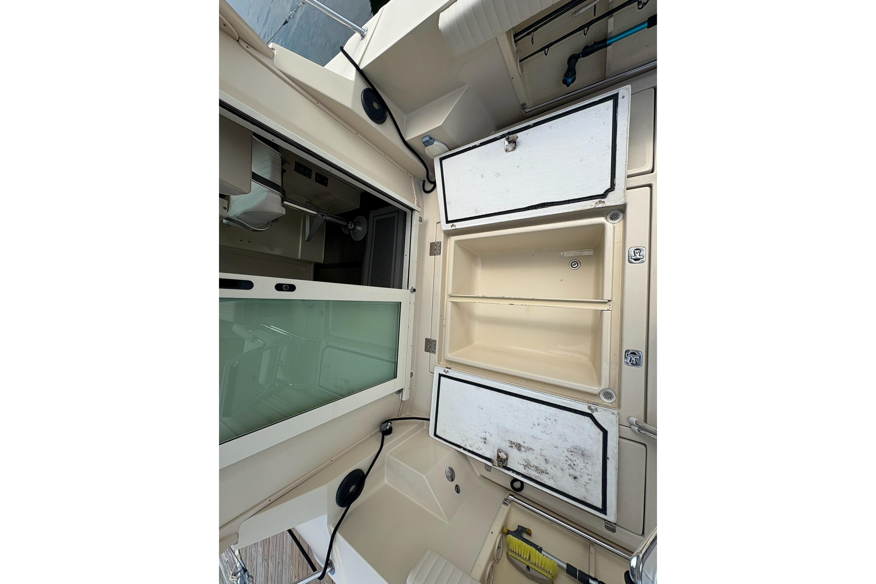 Interior view of a 2003 Albin 28 Tournament Express boat, featuring storage compartments.