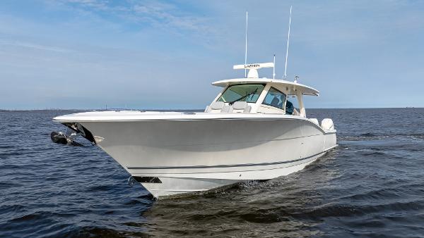 2025 Scout 425 LXF boat cruising on open water under a clear sky.