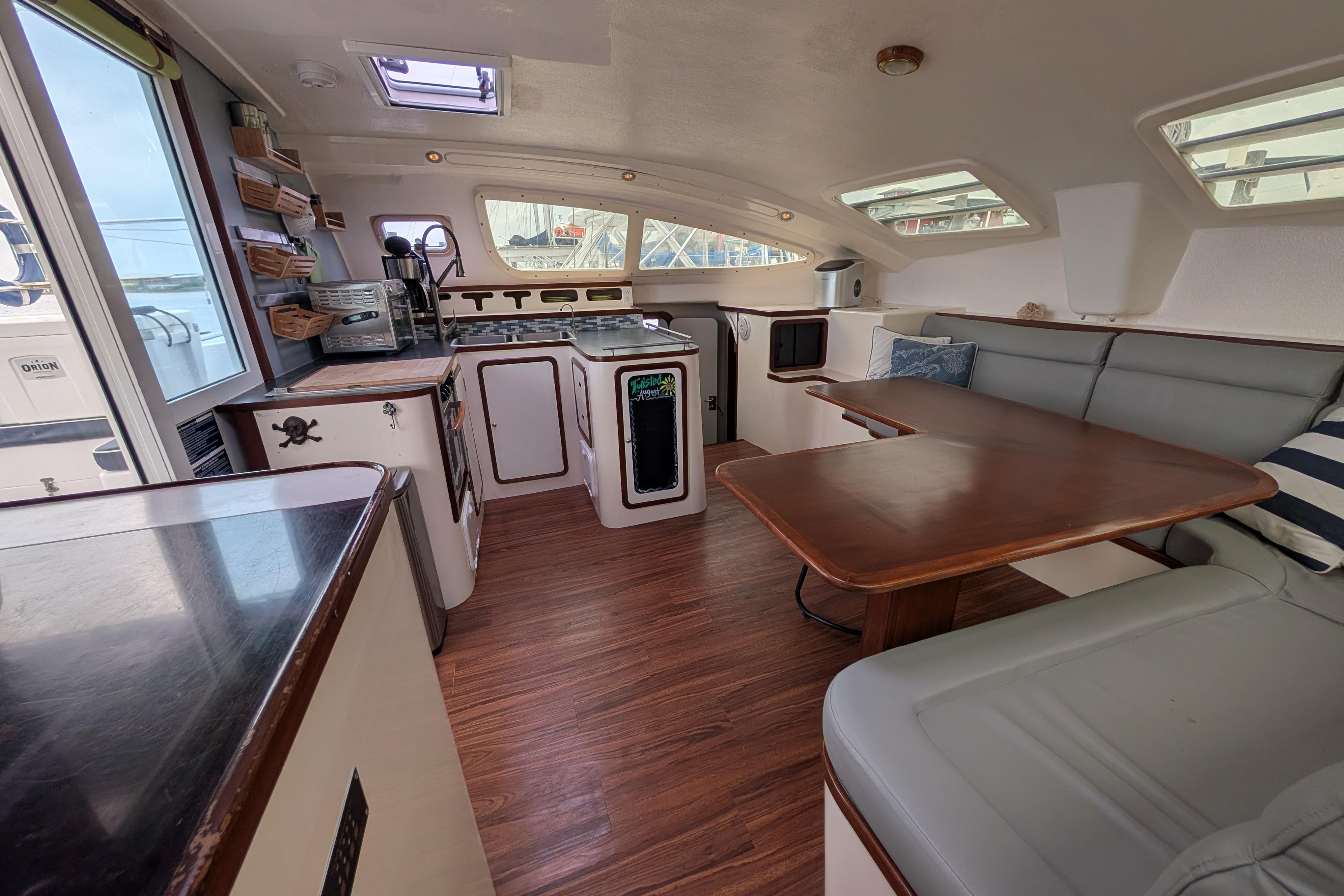 Interior of 1999 Island Spirit 37 yacht with cozy seating and modern kitchen amenities.